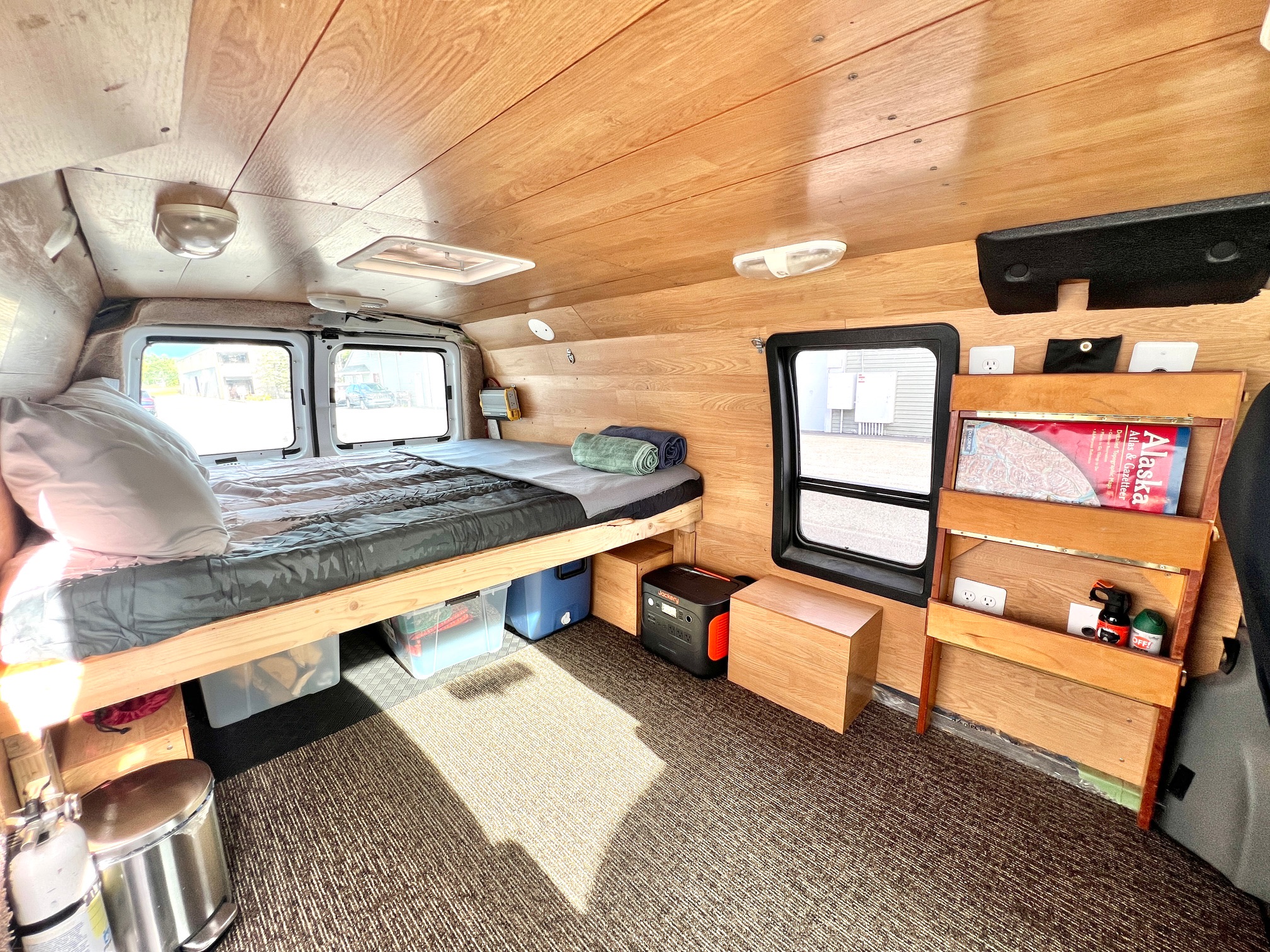 Experience van life in this RV rental: a wood-paneled camper with a bed, windows, and storage for travel.. Ford Econolline 250s 2006