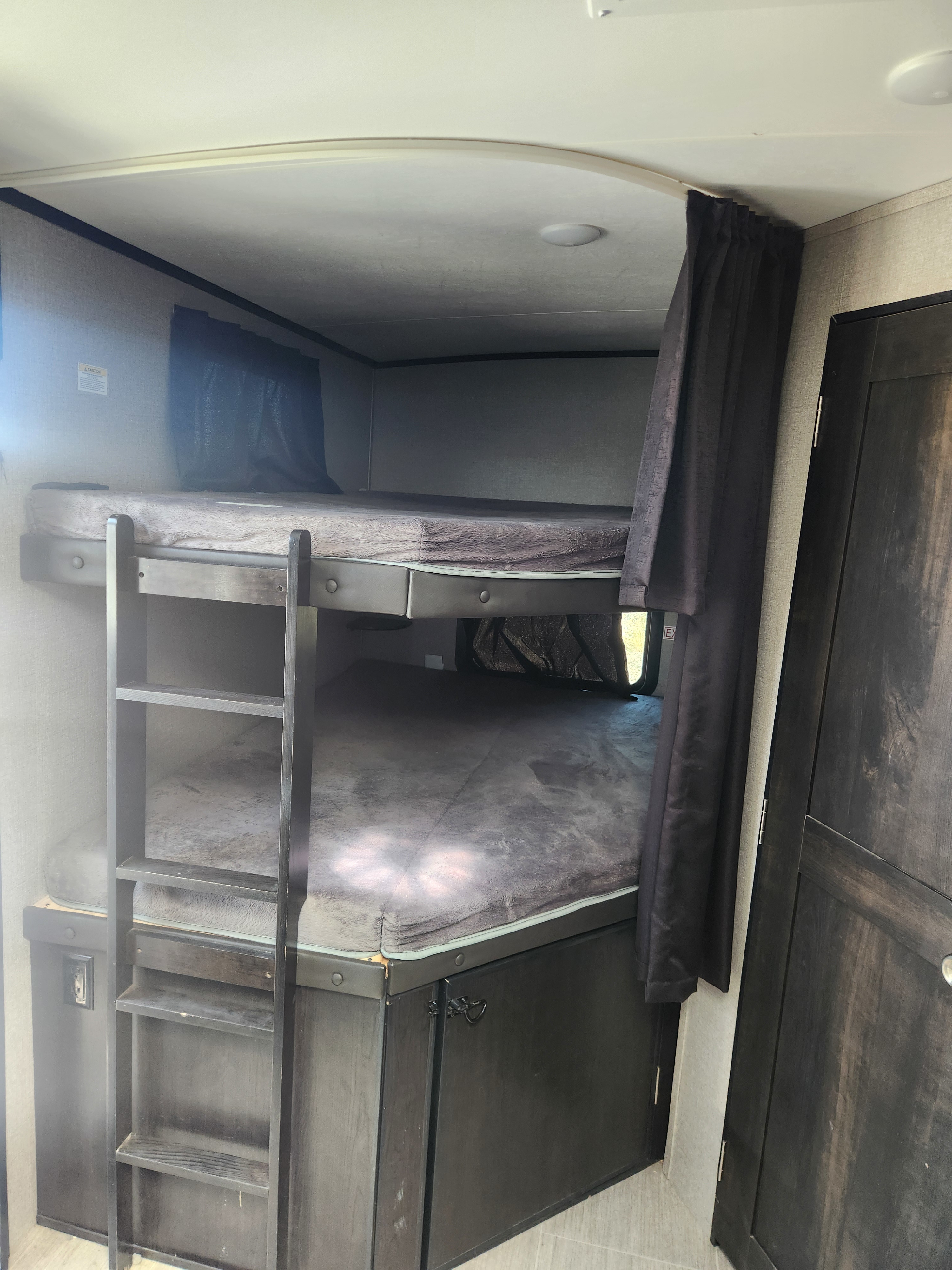 Inside this RV rental, find a well-equipped kitchen with a sink, stovetop, microwave, and ample cabinets, ready for your travels.. Jayco White Hawk 2020