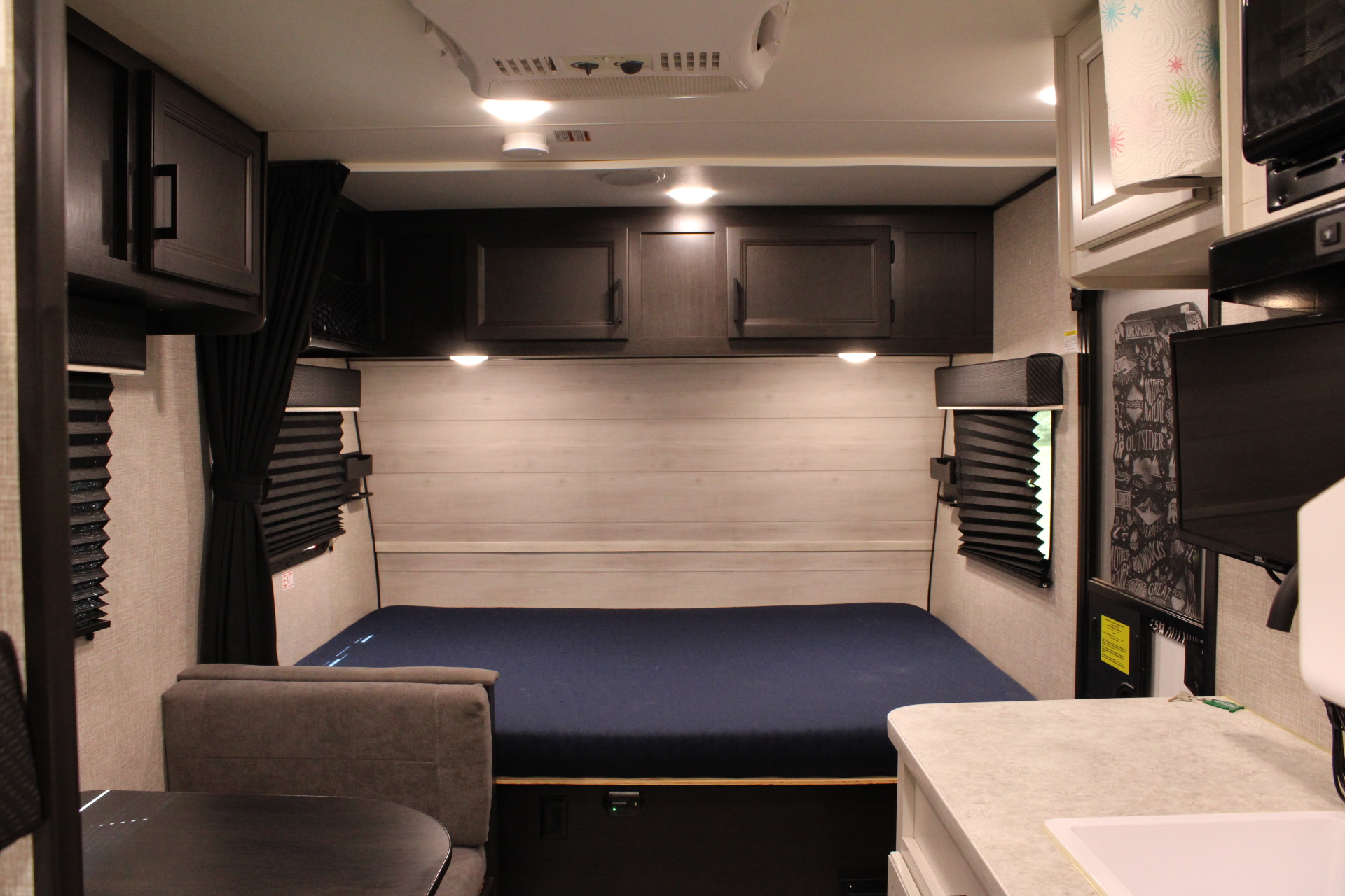 Cozy RV rental interior featuring a bed, ample storage, and functional kitchenette for travel.. Jayco Jay Flight 2022