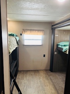 RV rental interior: A bright bunkhouse area with a window, wood-look floor, and two sets of comfortable bunk beds visible.. Forest River Palomino Puma 2019