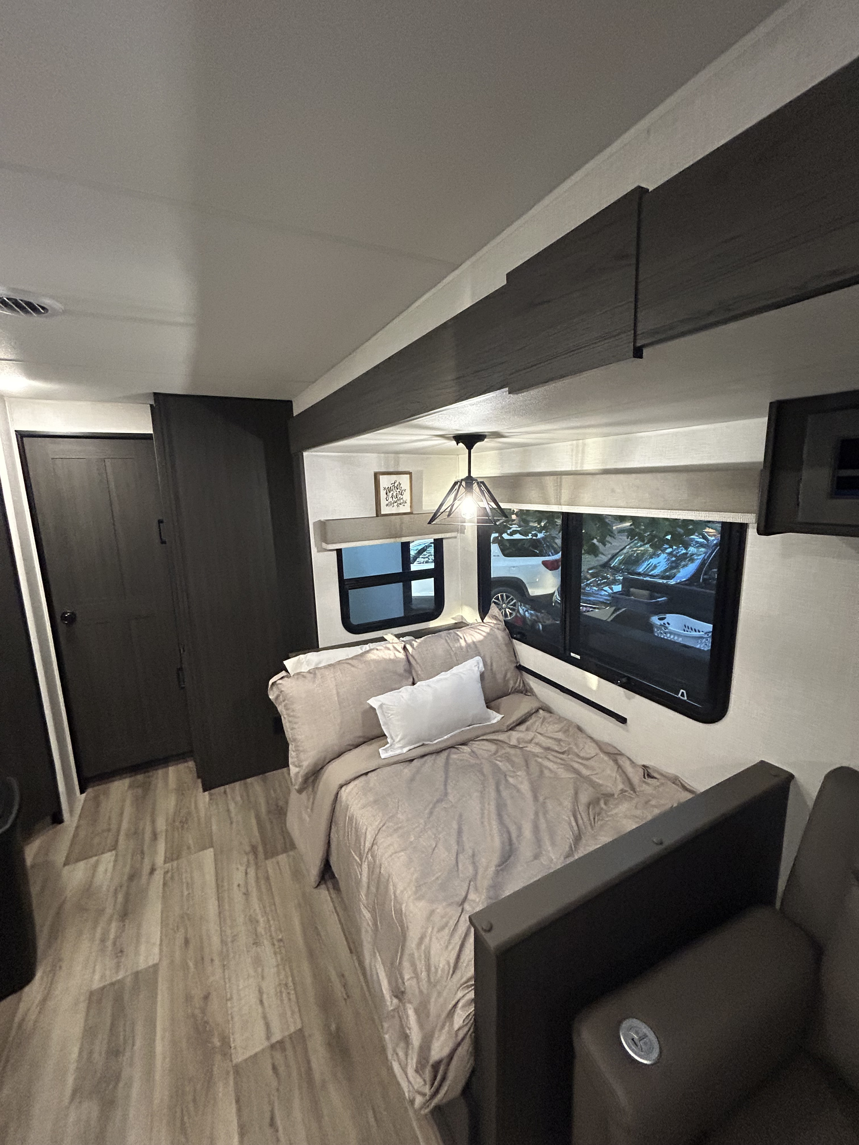 RV rental interior featuring a cozy bedroom setup with a comfortable bed, large windows, and built-in storage.. Venture Rv SPORTTREK TOURING EDITION 2025