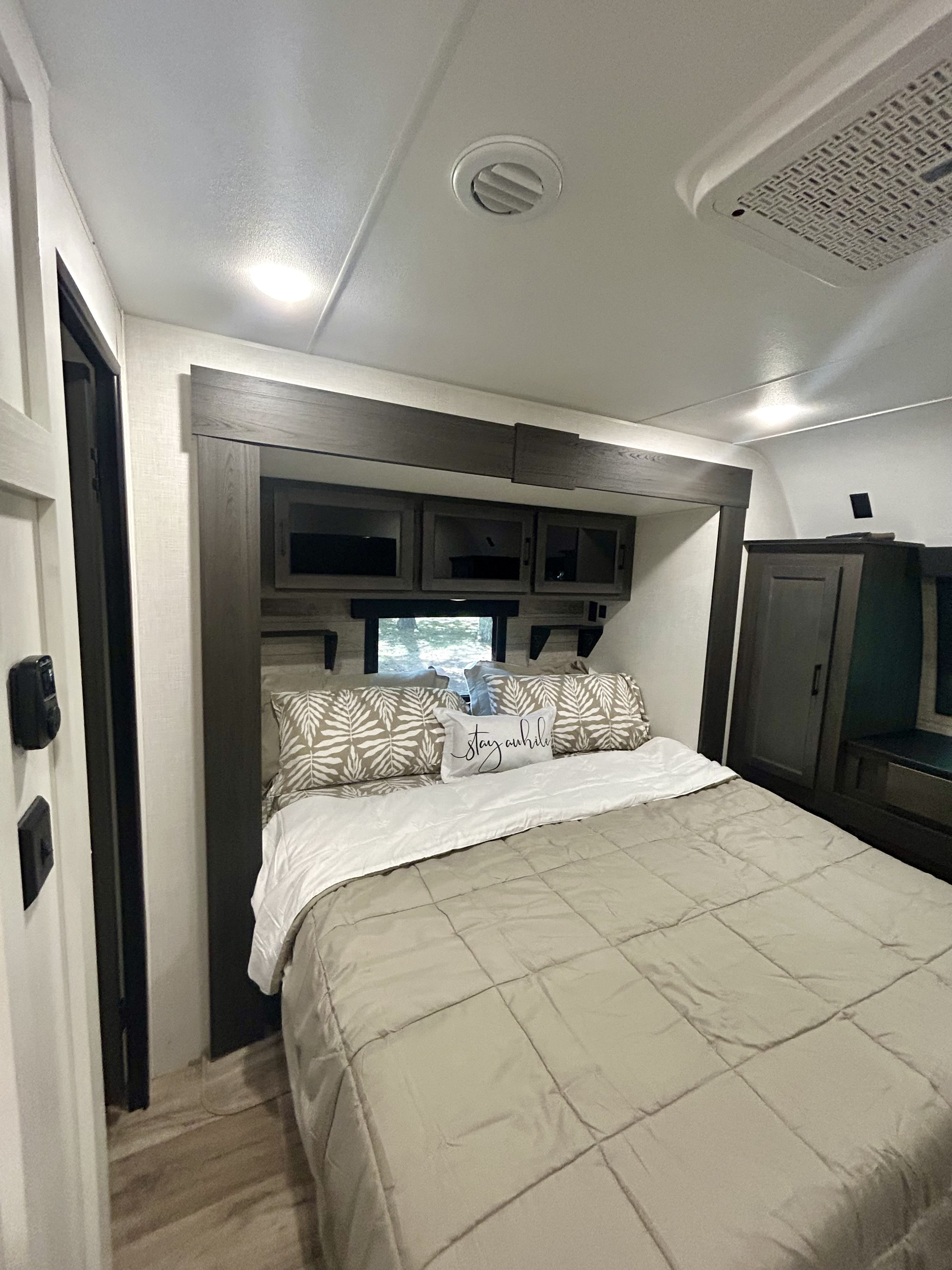 RV rental bedroom interior featuring a comfortable bed, overhead storage, and modern design.. Venture Rv SPORTTREK TOURING EDITION 2025