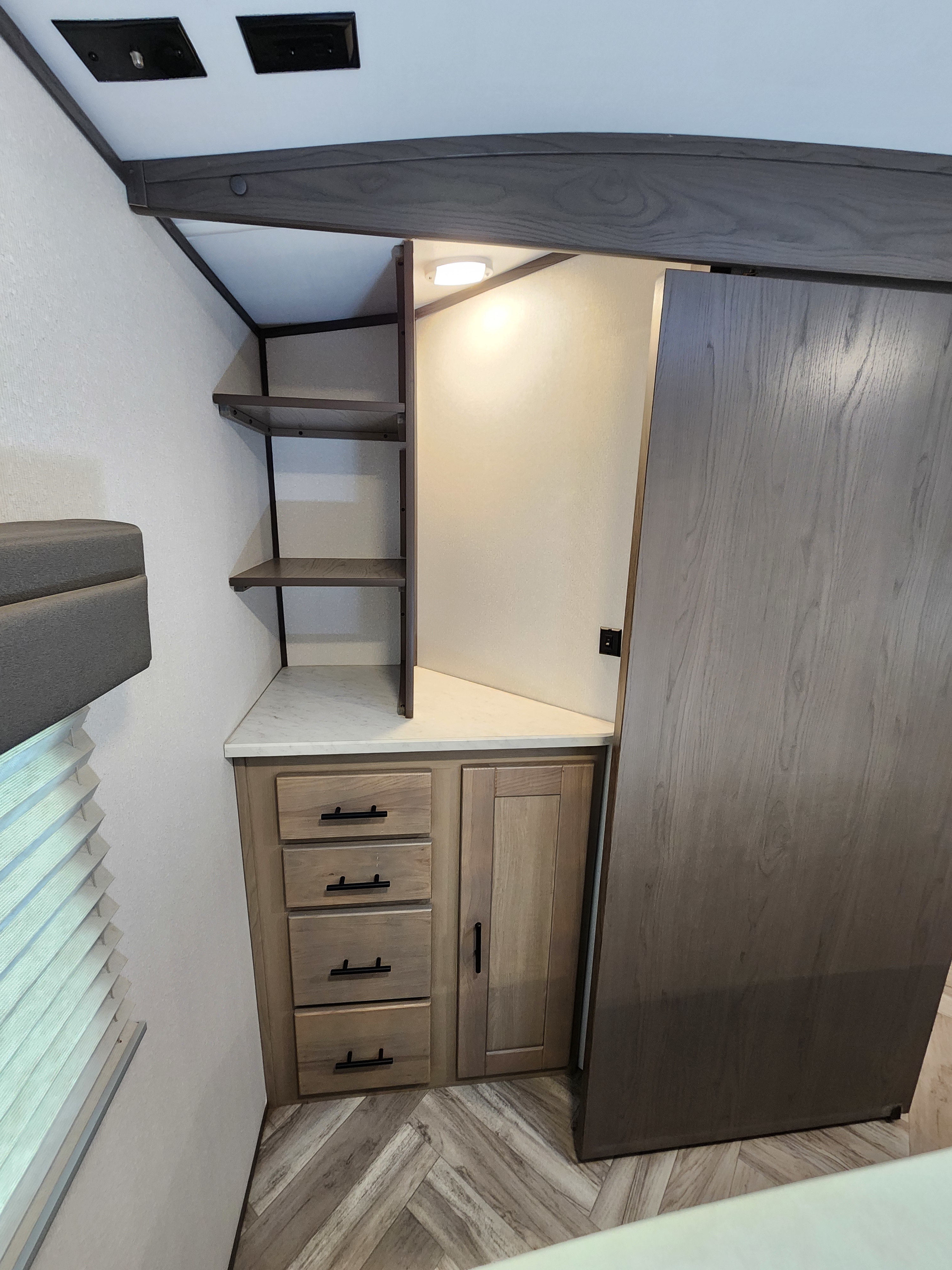 Compact RV rental storage: shelves, drawers, and a sliding door optimize space. Well-lit interior for travelers.. Cruiser RV Shadow Cruiser 2021
