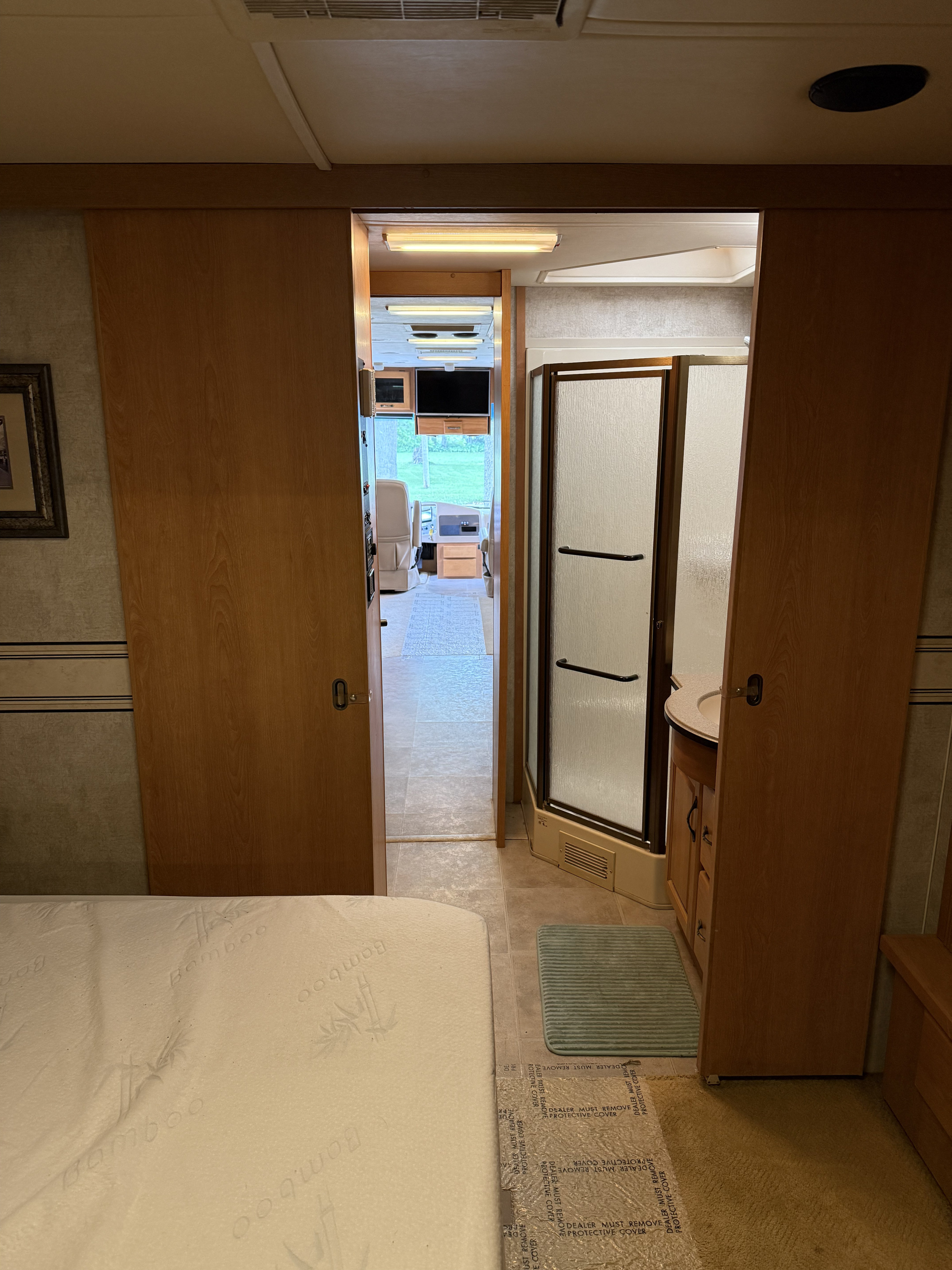 Explore this RV rental's spacious interior: bedroom, bath with shower, and living area with cockpit view.. Monaco Knight 2006
