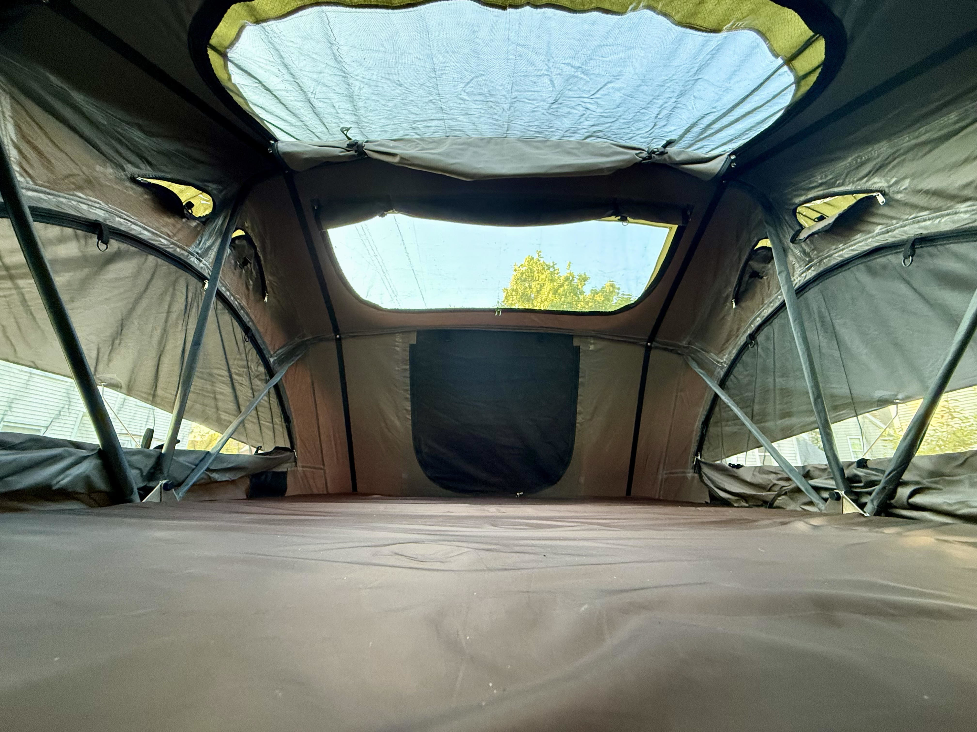 Inside an RV rental rooftop tent, showcasing the spacious sleeping area and views. Ideal for camping adventures.. 1C4PJXDN9RW109044 Other 2024