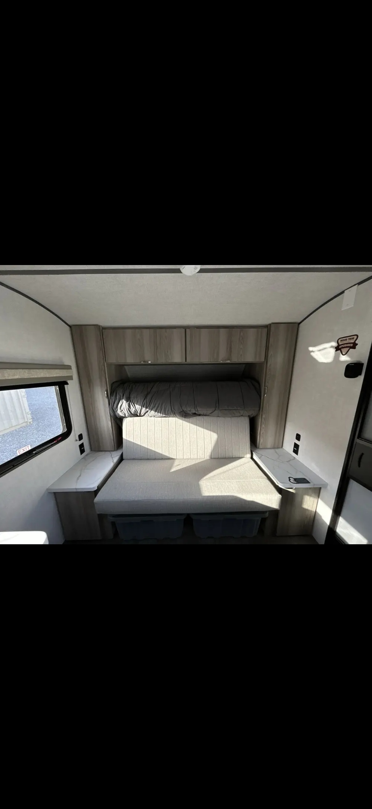 RV rental interior features a convertible sofa bed, overhead cabinets, and practical side tables.. Forest River Salem 2025