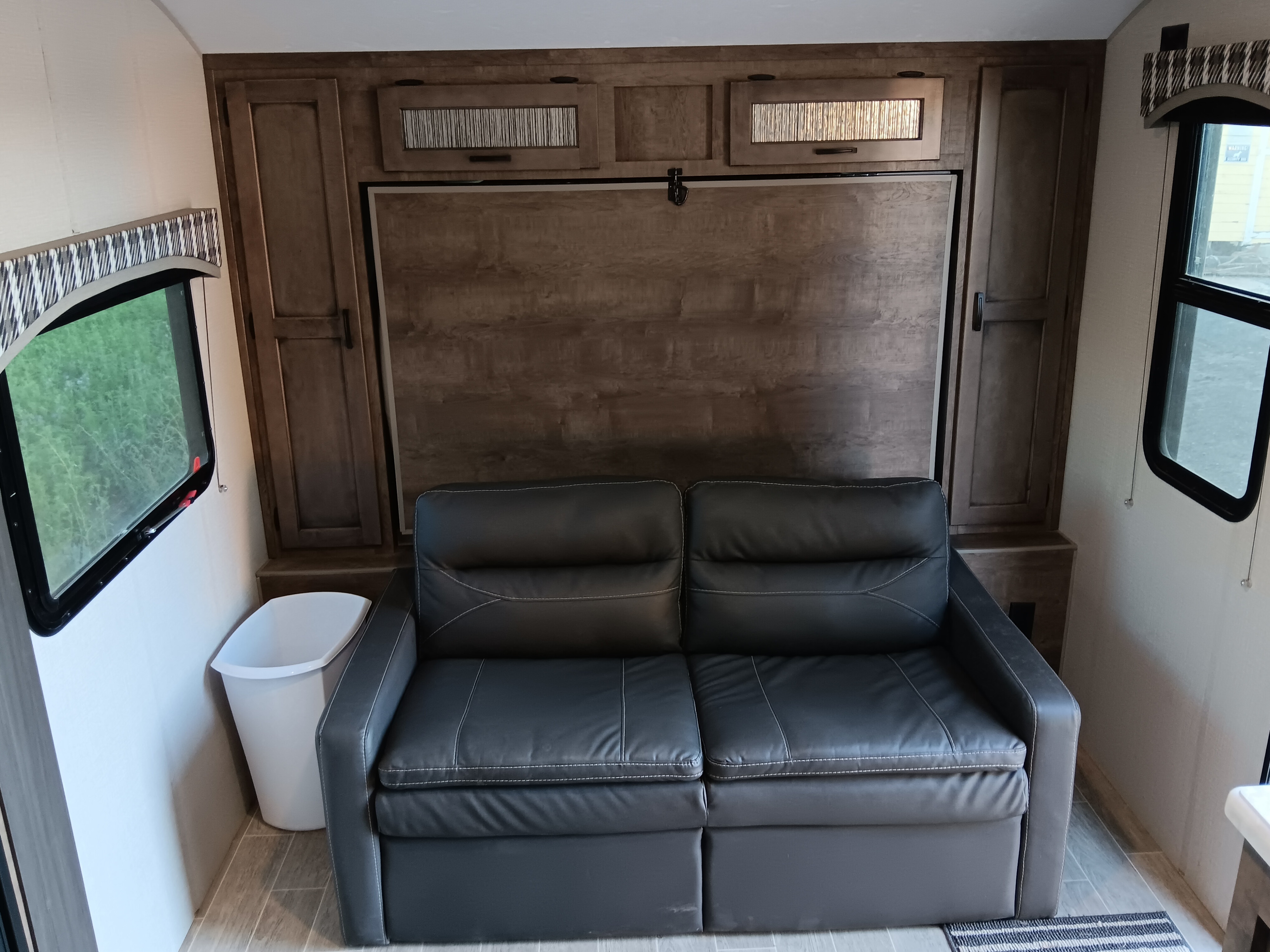 RV rental interior: sofa, folded wall bed, and sleek cabinets for a comfy stay.. Sonic Sonic Trailer 2021