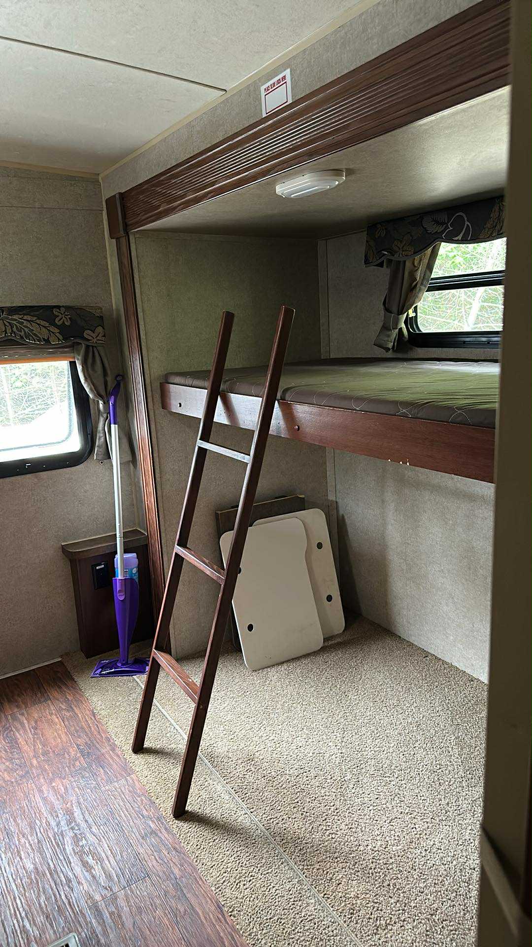 RV rental: Cozy bunk bed interior with a wooden ladder, window, folded tables & mop.. Forest River Rockwood Signature Ultra Lite 2015