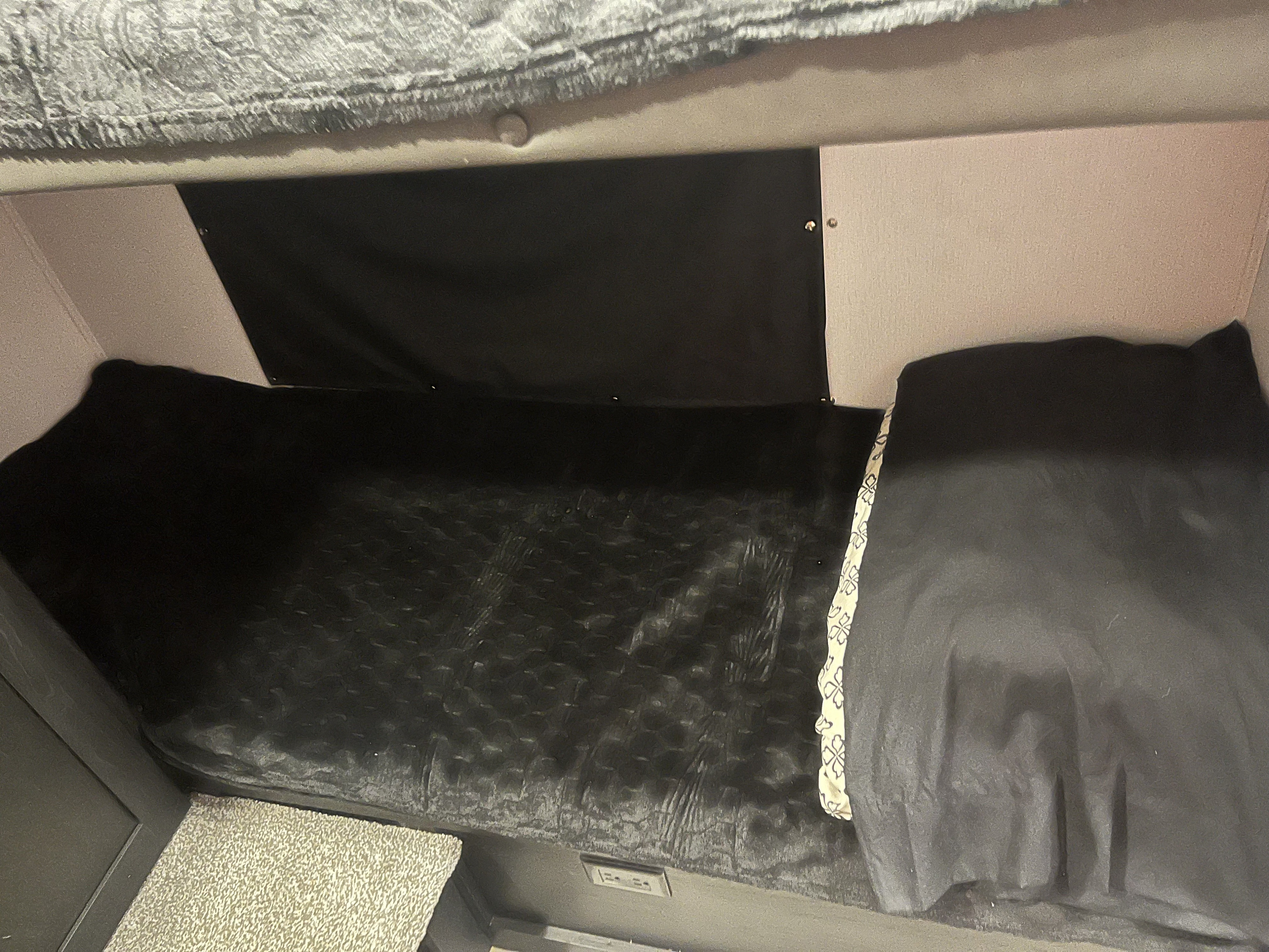 Inside this RV rental, find a compact bedroom with a TV, bed, and cozy comfort.. Coachmen 29SE 2022