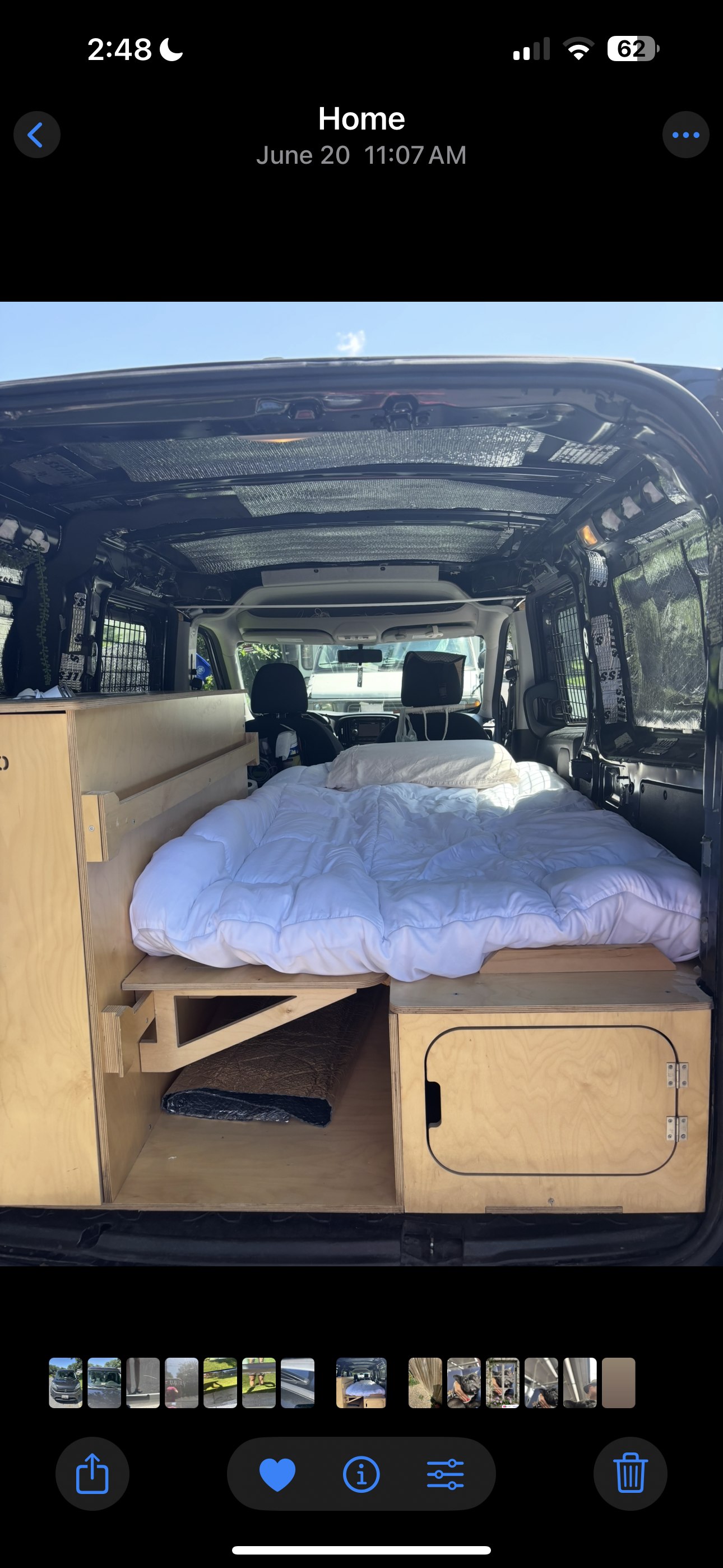 Inside a customized RV rental van: a comfy bed and built-in wooden storage, perfect for road trips.. Ram Promaster City 2018