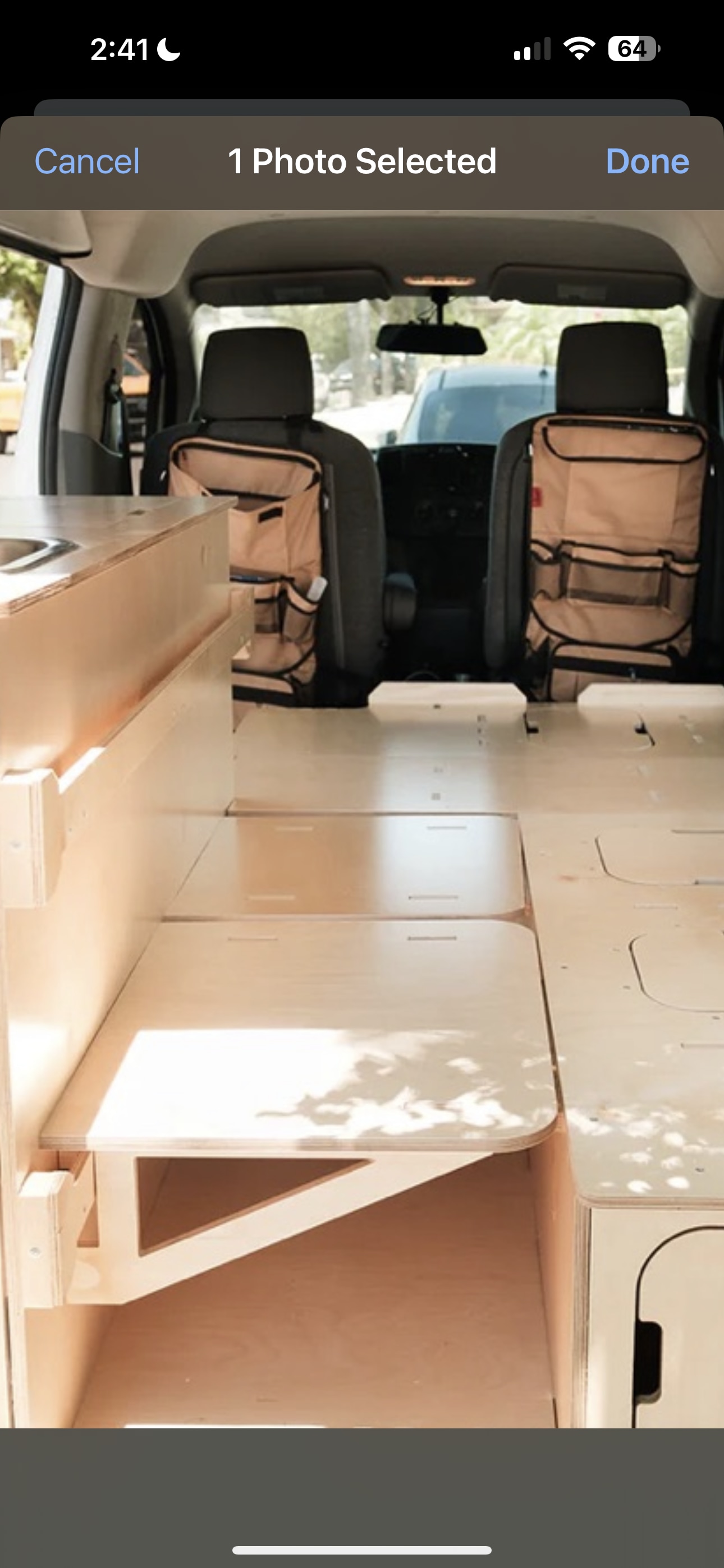 RV rental: Inside a camper van conversion, featuring light wood interior, modular bed, and seat back organizers.. Ram Promaster City 2018