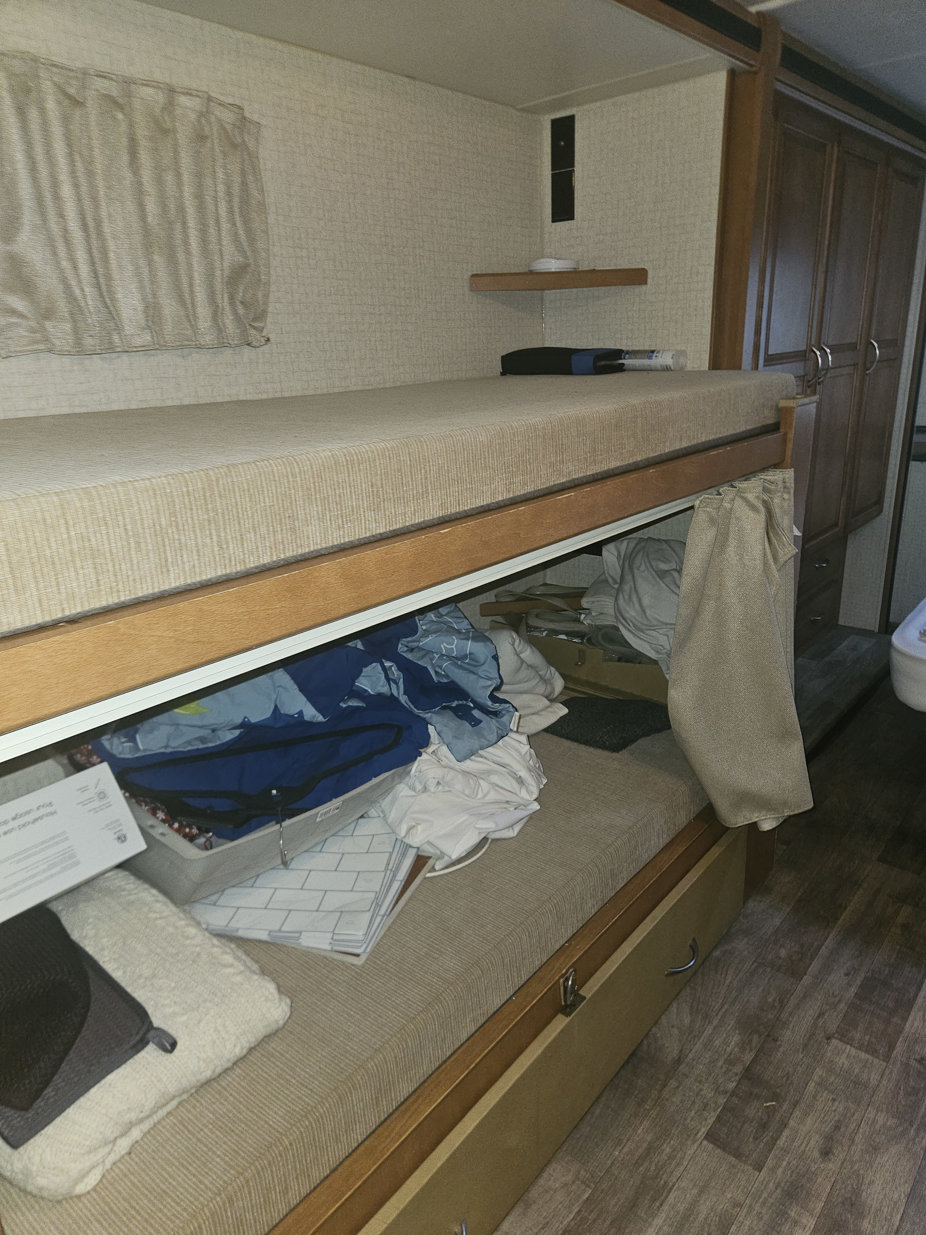 Bunk beds inside an RV rental, showing a sleeping area and storage for clothing and other items.. Other Other 2017