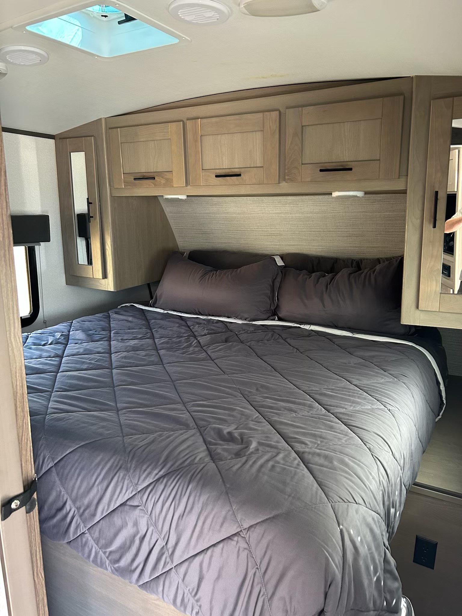 This RV rental features a comfortable bedroom with a large bed, ample overhead storage, and natural light from the skylight.. Cruiser RV Shadow Cruiser 2022