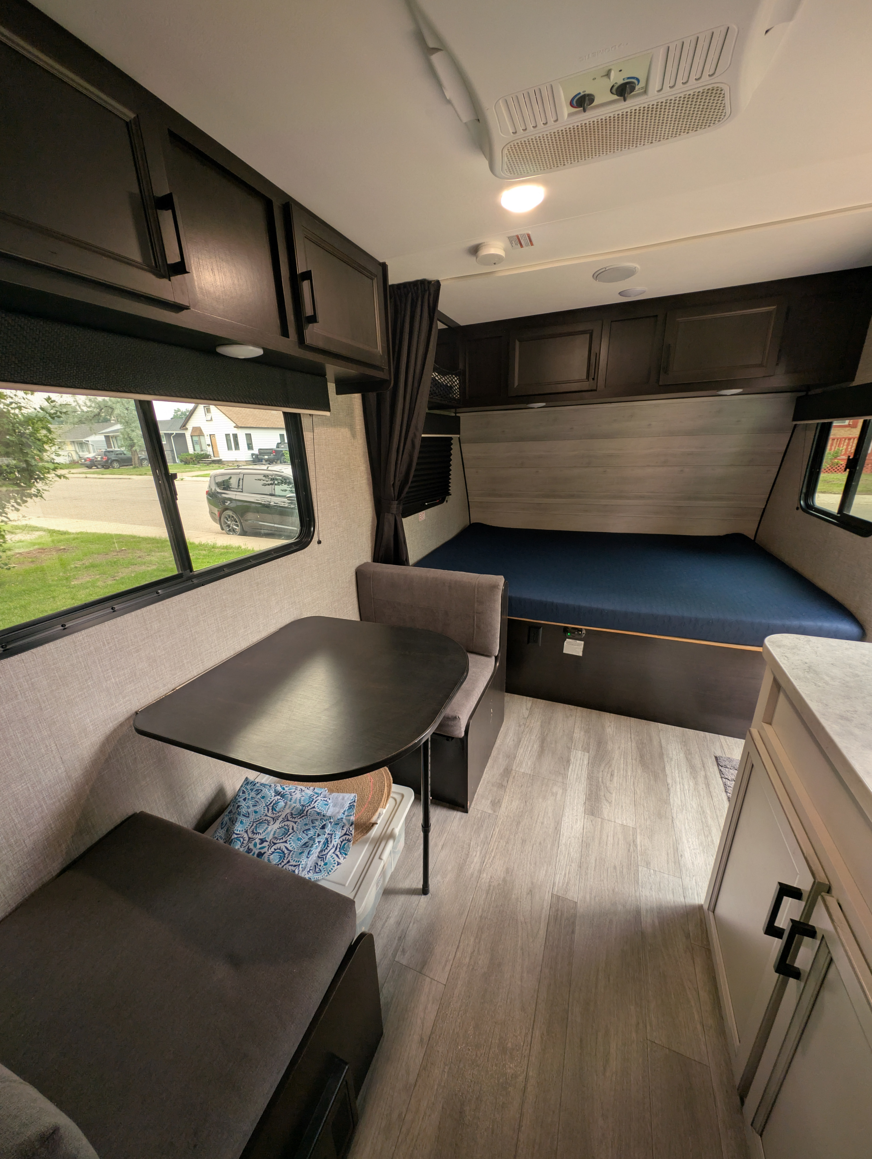 RV rental interior with dinette, bed, and cabinetry, offering a cozy living space.. Jayco Jay Flight SLX 2022