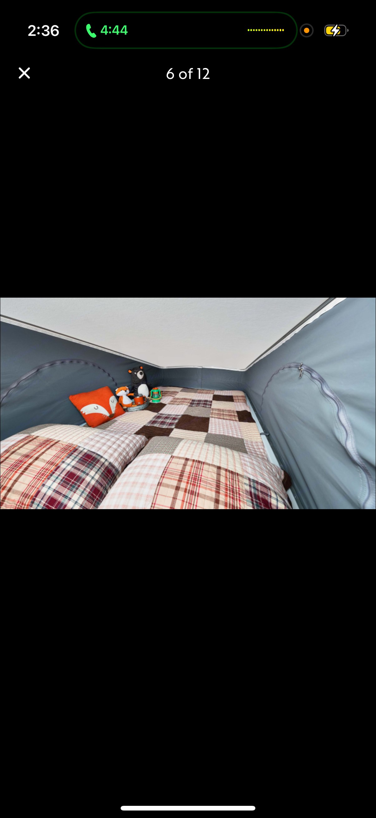 RV rental: Cozy pop-top bed features plaid bedding & stuffed animals, perfect for a comfortable camping rest.. Winnebago Solis 2023
