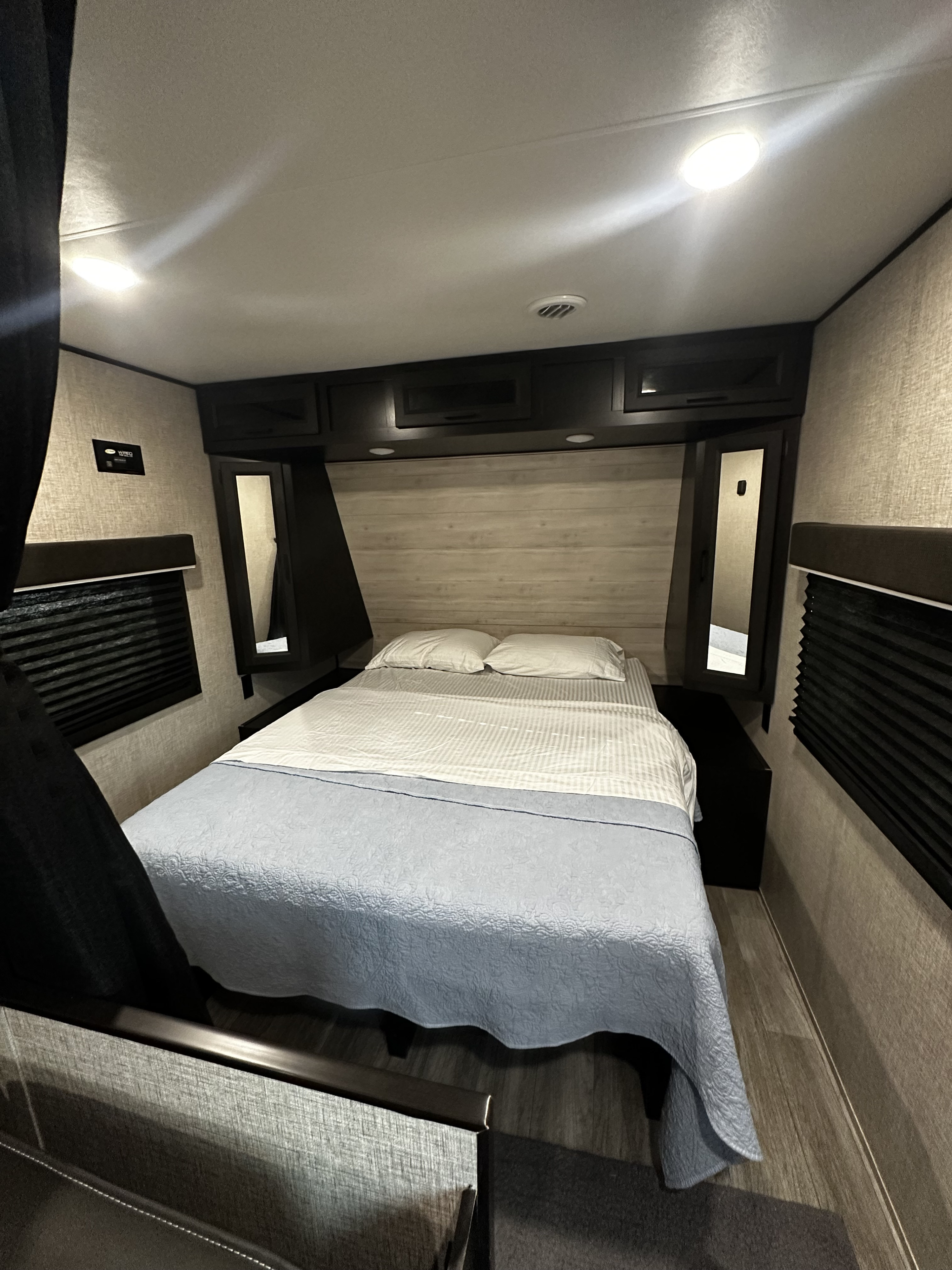 Cozy RV rental bedroom featuring a comfy bed, integrated storage, and ambient lighting, ideal for adventurous travel.. Jayco Jay Flight 2021