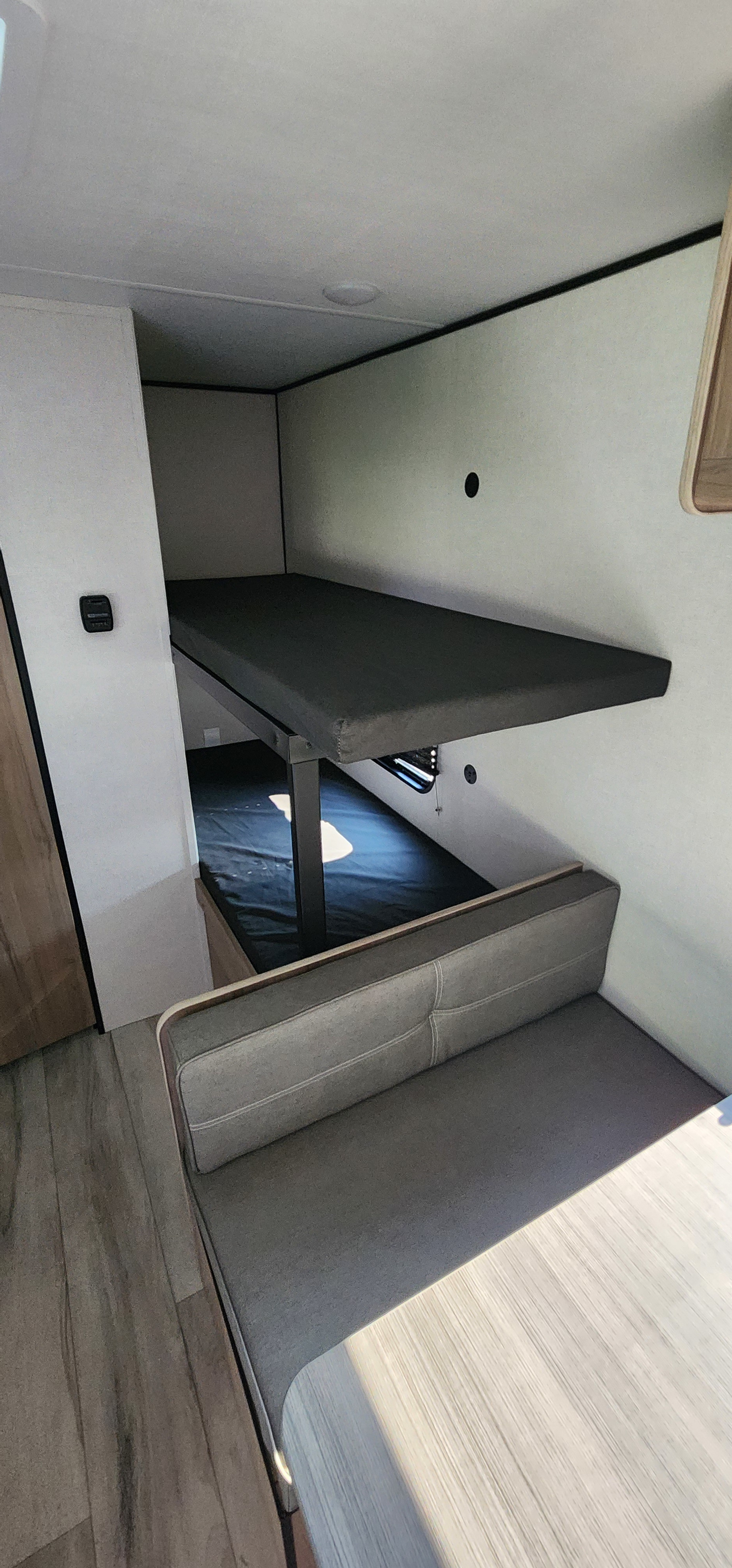 This rv rental bunkhouse features a cozy top bunk above a convertible dinette, perfect for families.. Coleman 17B 2026