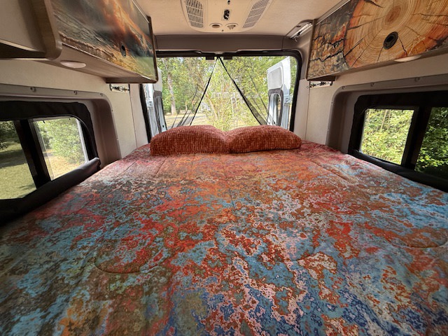 Wanda set up with a queen size bed including sheets, blanket, comforter and pillows.. Winnebago Solis 59PX 2025