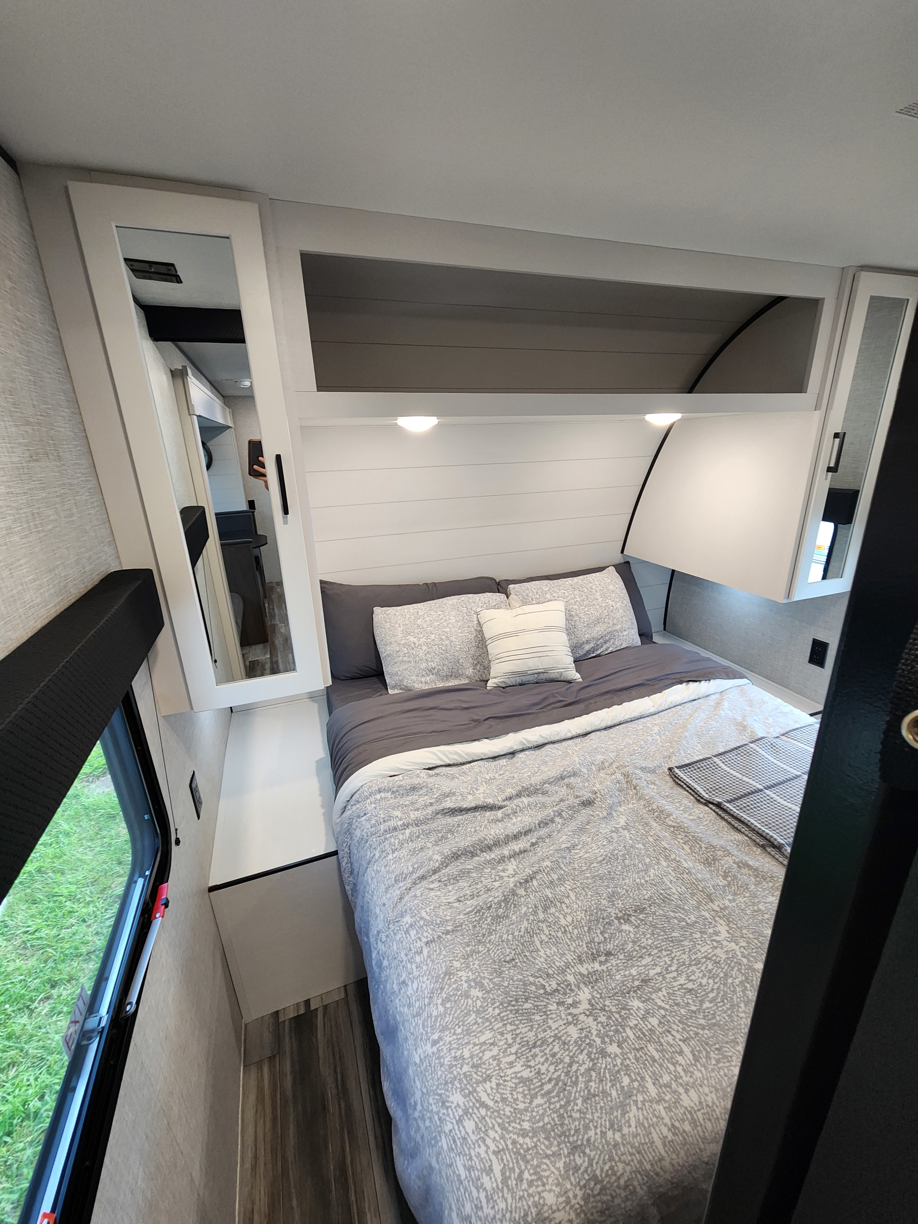 Experience comfort in this stylish RV rental bedroom. Features a comfy bed, shiplap headboard, and storage.. Jayco Jay Flight SLX 2024