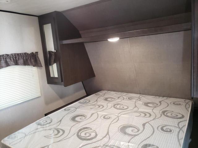 Spacious RV rental bedroom with a comfy bed, window blinds, and. Heartland RVs Prowler 2020