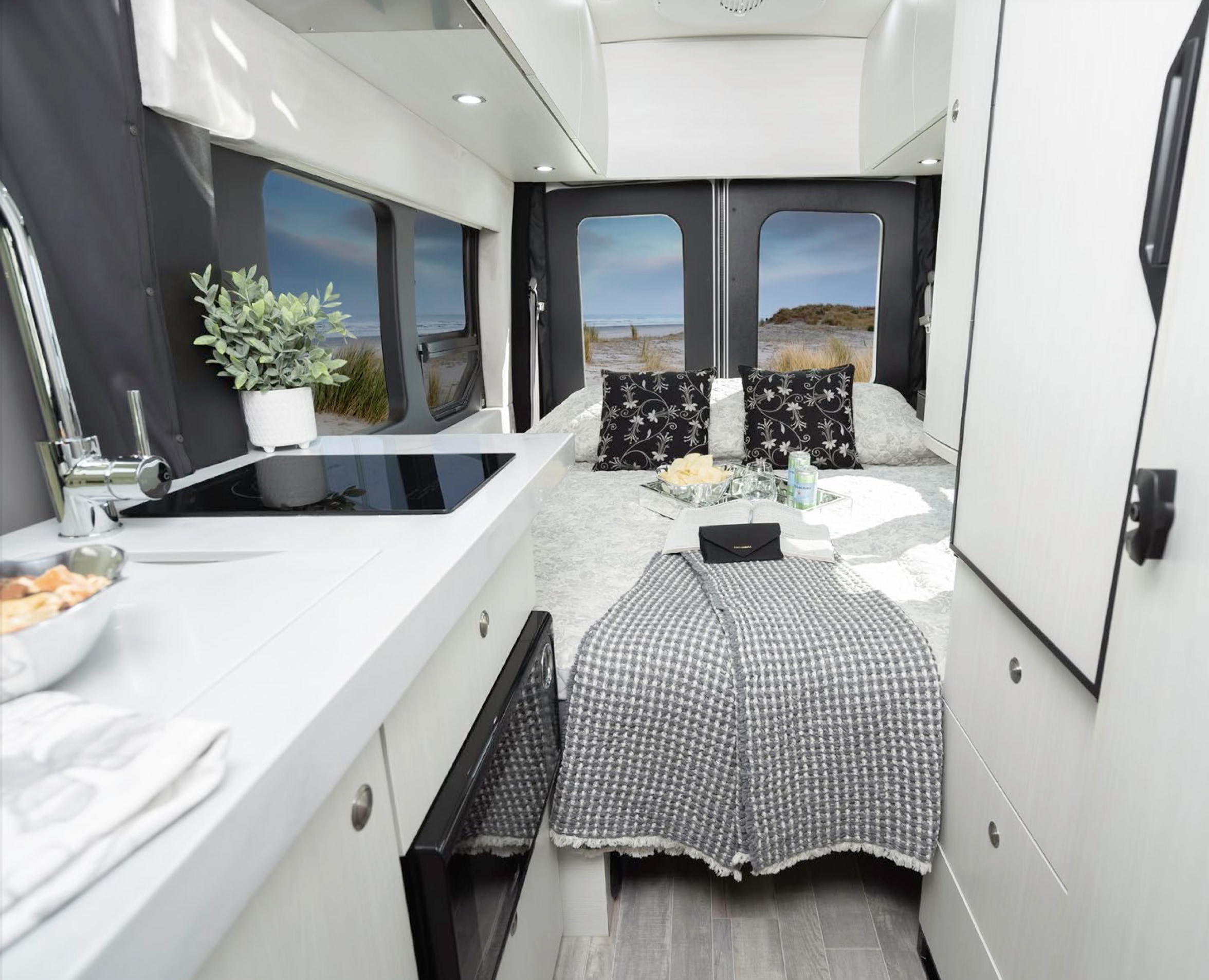 This rv rental offers a bright, modern interior with a comfy bed, functional kitchen, and scenic views.. Pleasure-Way Pleasure-Way Class B 2023