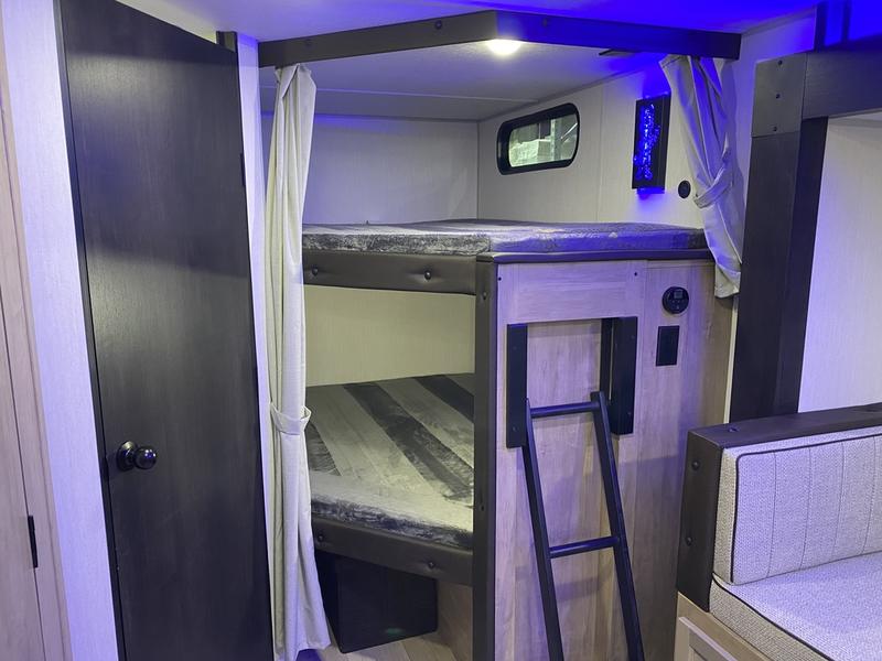 RV rental: Spacious bunk beds within a modern travel trailer, ideal for family adventures on the road.. Grey Wolf 26DBH 2025