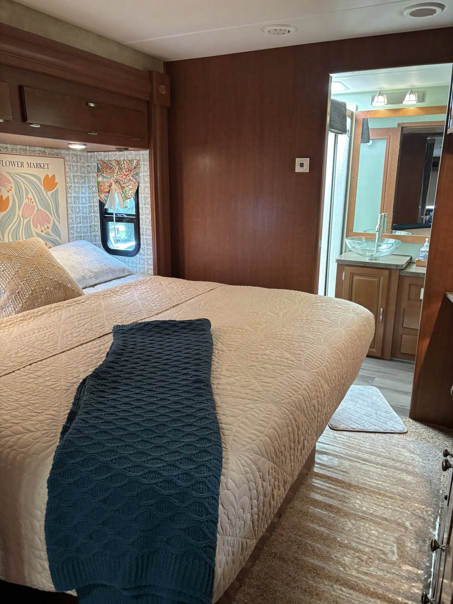 Experience comfort in this RV rental bedroom with a quilted bed, overhead cabinets, and a convenient bathroom vanity.. Georgetown Georgetown Motorhome 2011