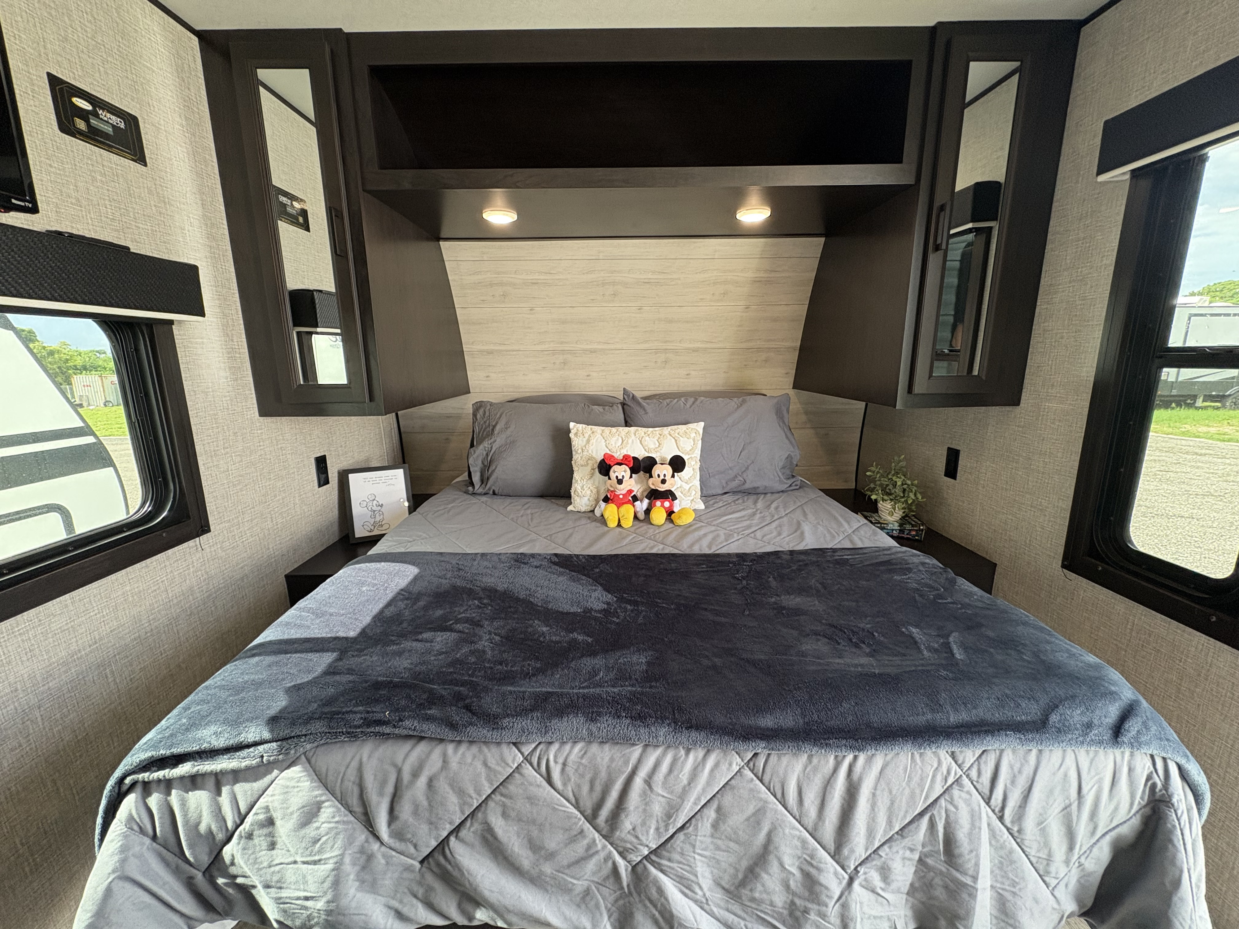 Cozy RV rental bedroom with Mickey & Minnie, grey bedding, and mirrored closets. Perfect for travel comfort.. Jayco Jay Flight 2023