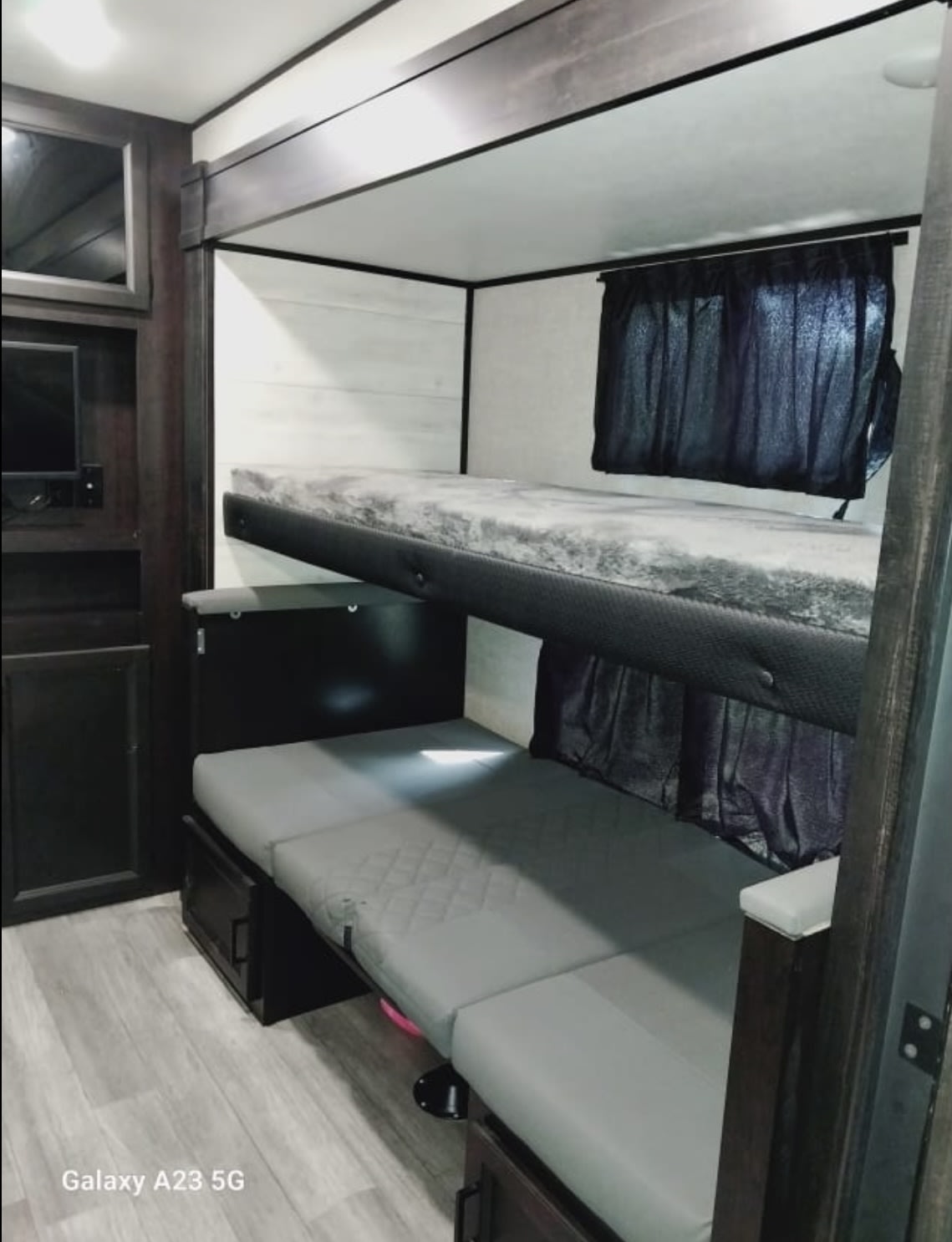 RV rental interior: View of compact bunk beds, lower convertible bed, & storage. Cozy space for trips.. Jayco Jay Flight 2023