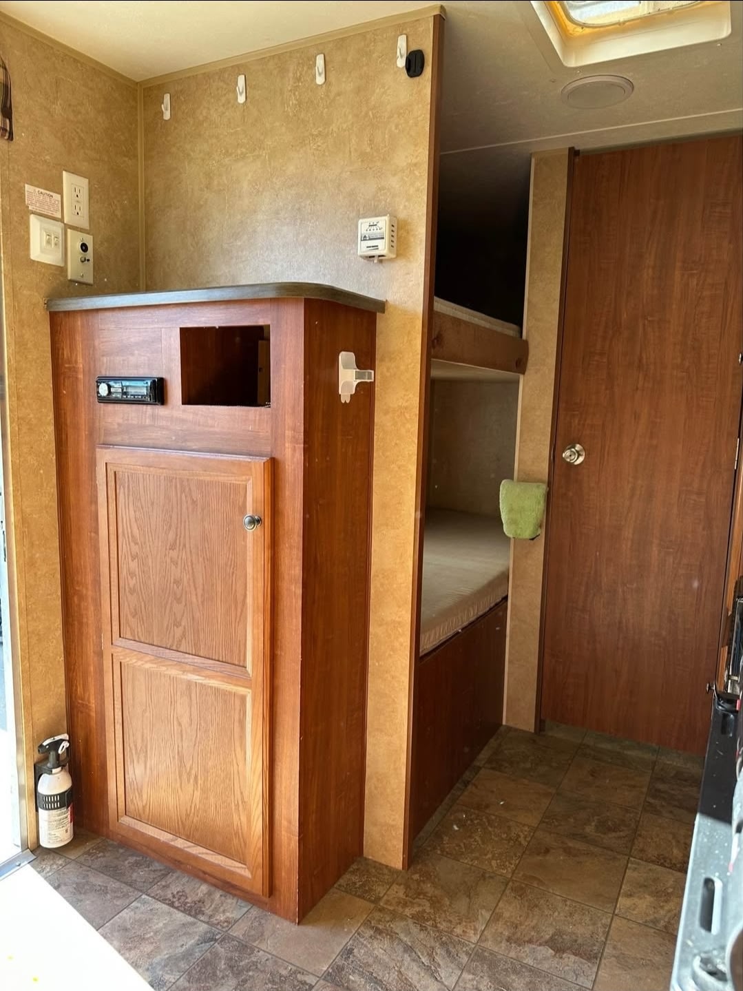 RV rental: Interior shows wood-paneled entertainment center, stereo, bunk beds, and a door, providing comfort for your journey.. Jayco Jay Flight Swift SLX 2012