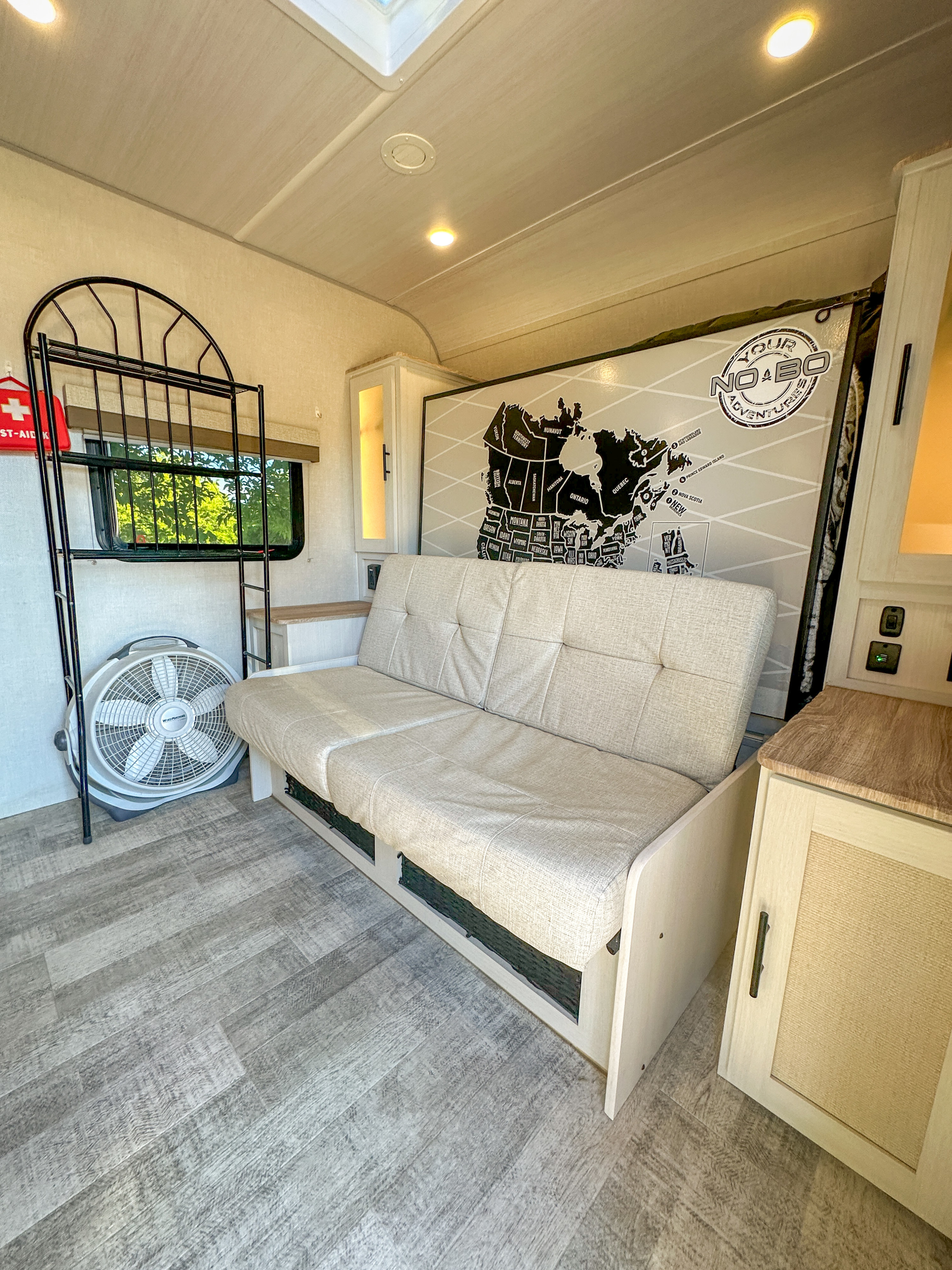 RV rental interior: cozy camper with sofa, bunk, and travel map for your next adventure.. Forest River NoBo 20.3 2024