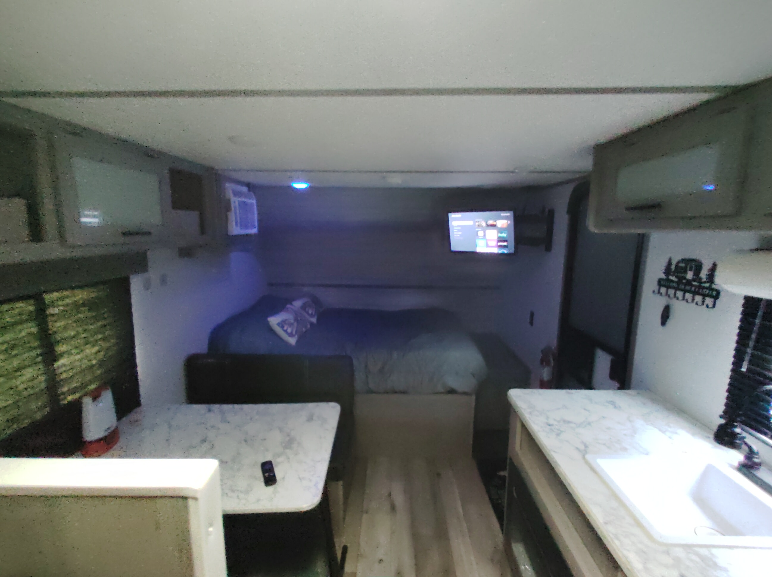 Inside this RV rental: a compact interior with bed, dinette, kitchen, and storage for comfortable travel.. Dutchmen 17B 2024