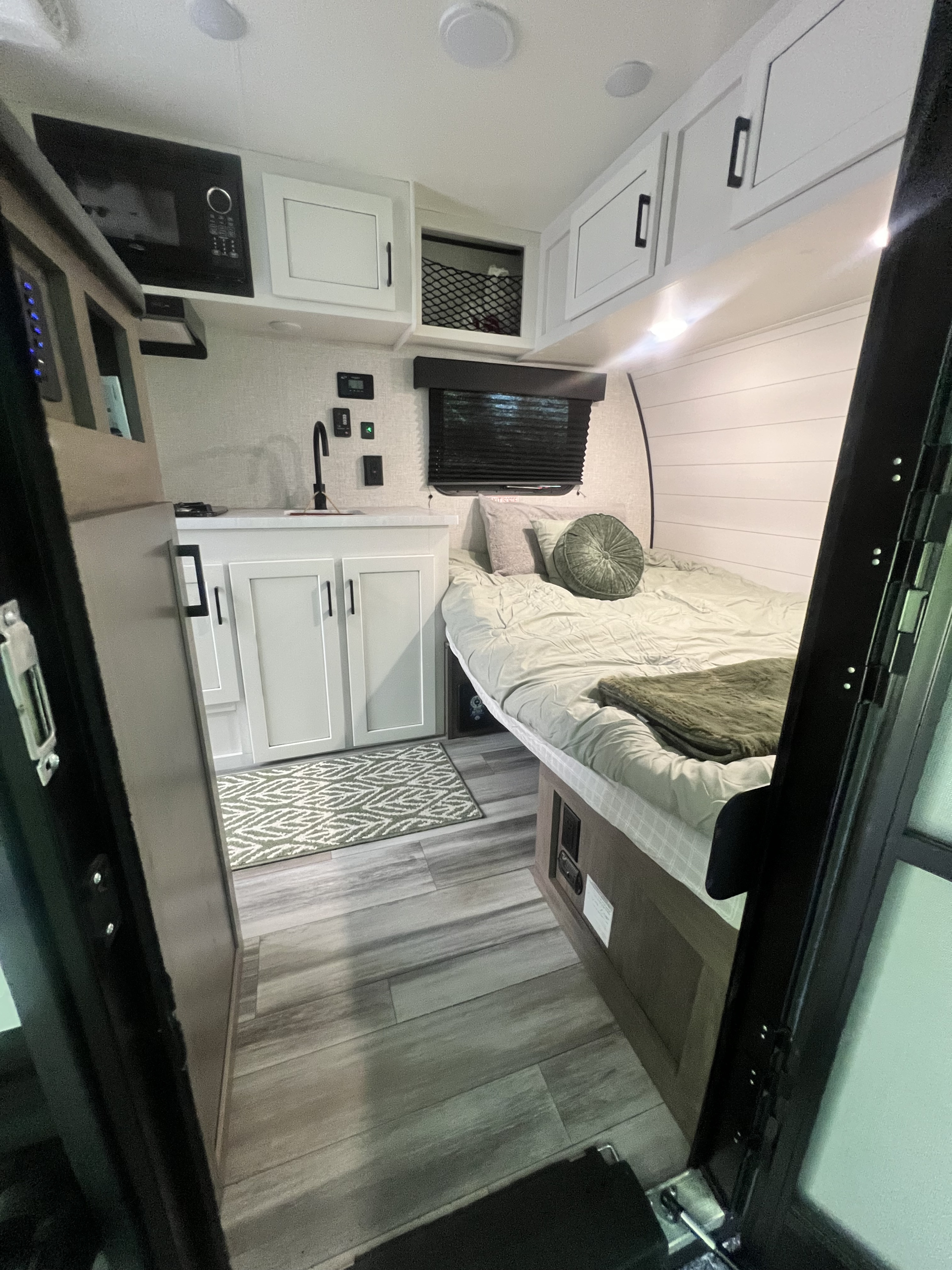 This RV rental offers a tidy interior with a plush bed, functional kitchen area, and sleek overhead cabinets.. Jayco Jay Flight SLX Baja Edition 2024