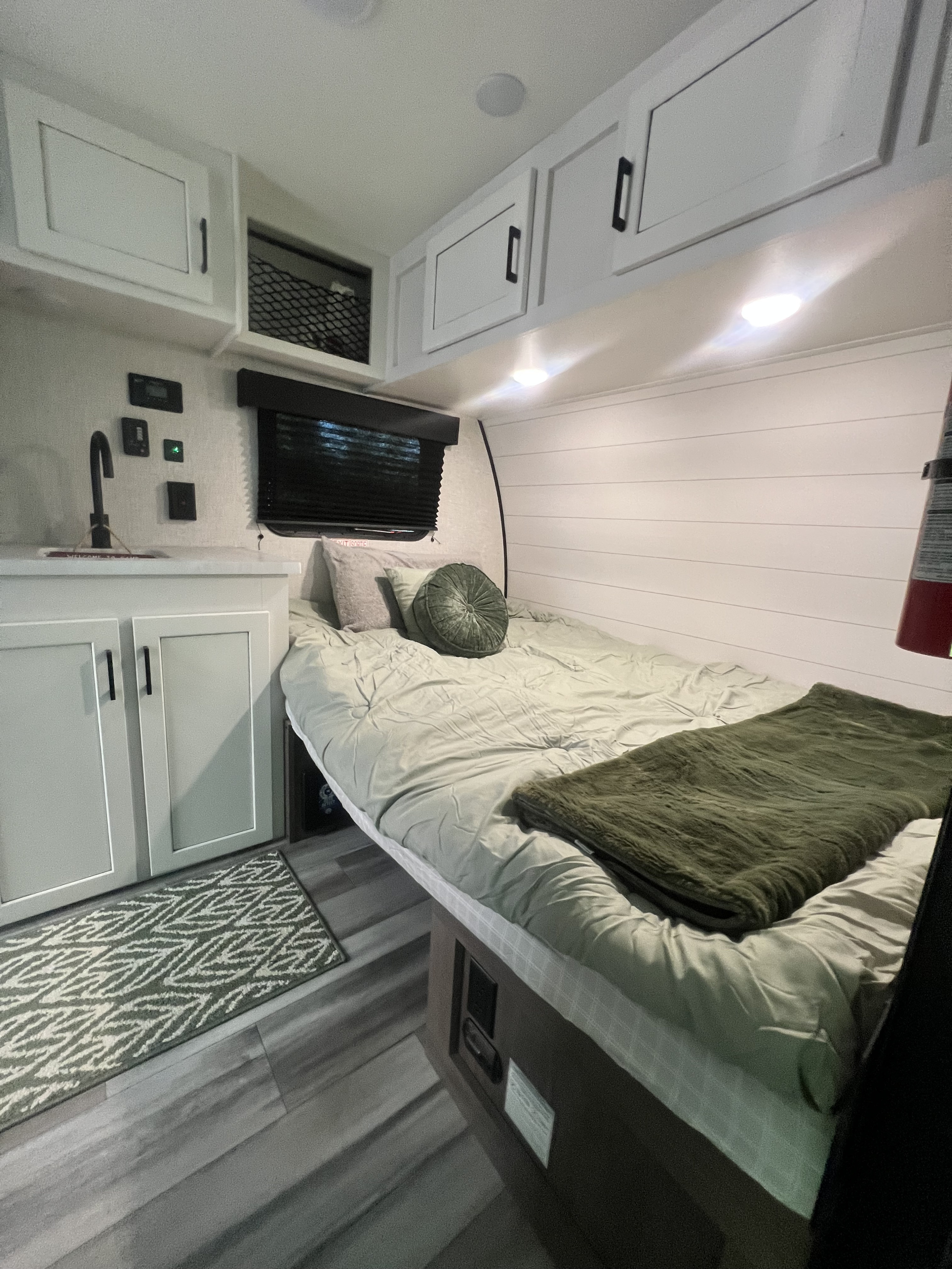 RV rental: Bright, cozy camper interior with a comfortable bed, white shiplap walls, and modern cabinets overhead.. Jayco Jay Flight SLX Baja Edition 2024