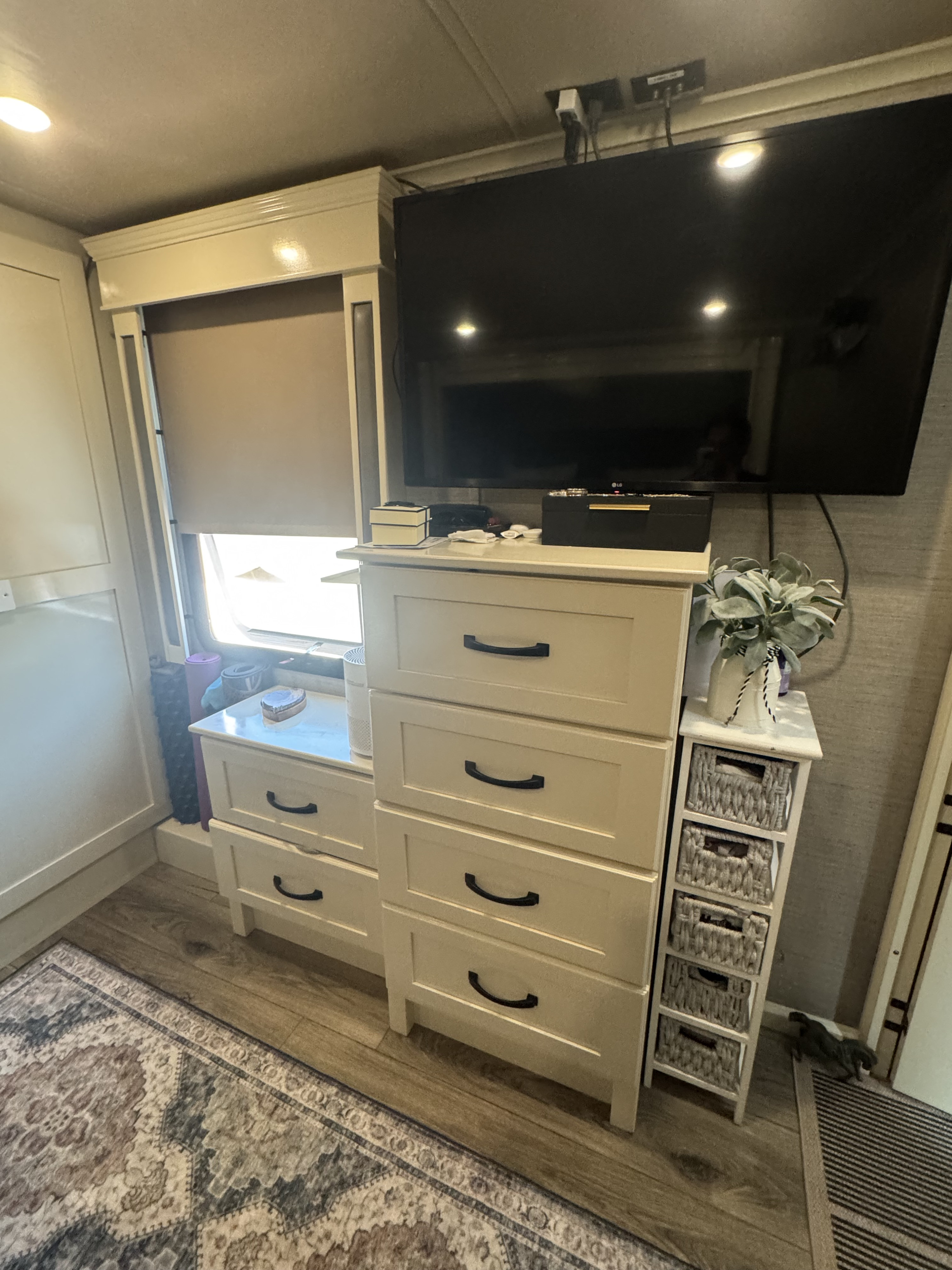 Cozy RV rental bedroom with ample storage: modern dresser, TV, and organized shelving for comfortable living.. Vanleigh RV Vilano 2022