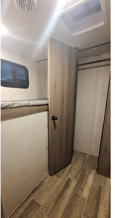 RV rental interior: Bunk bed, door, and closet. Provides functional and comfortable living space.. Gulf Stream Ameri-Lite 2022