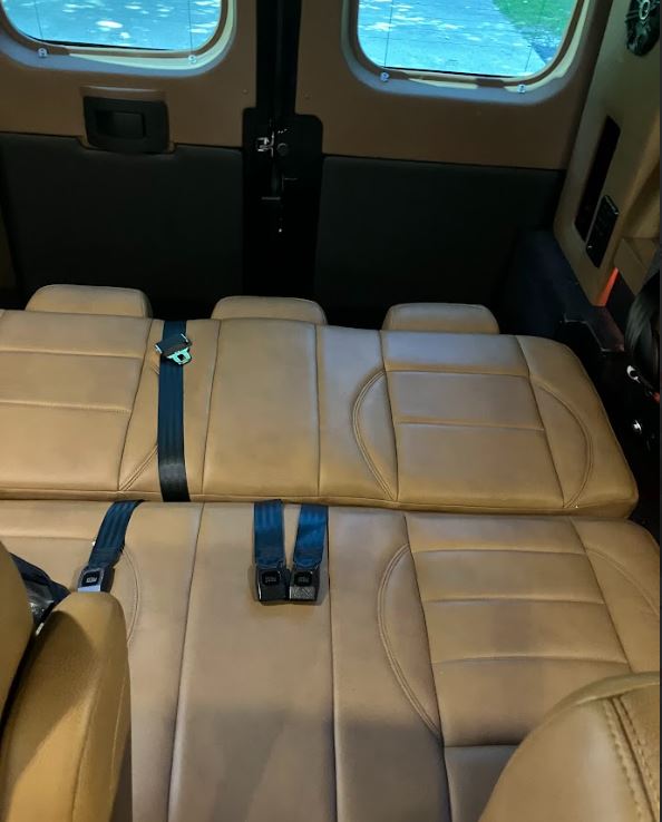 Inside an RV rental: plush tan seats with safety belts, offering comfort & space for travel. Windows visible.. Dodge Sprinter 2500 170ext 2021