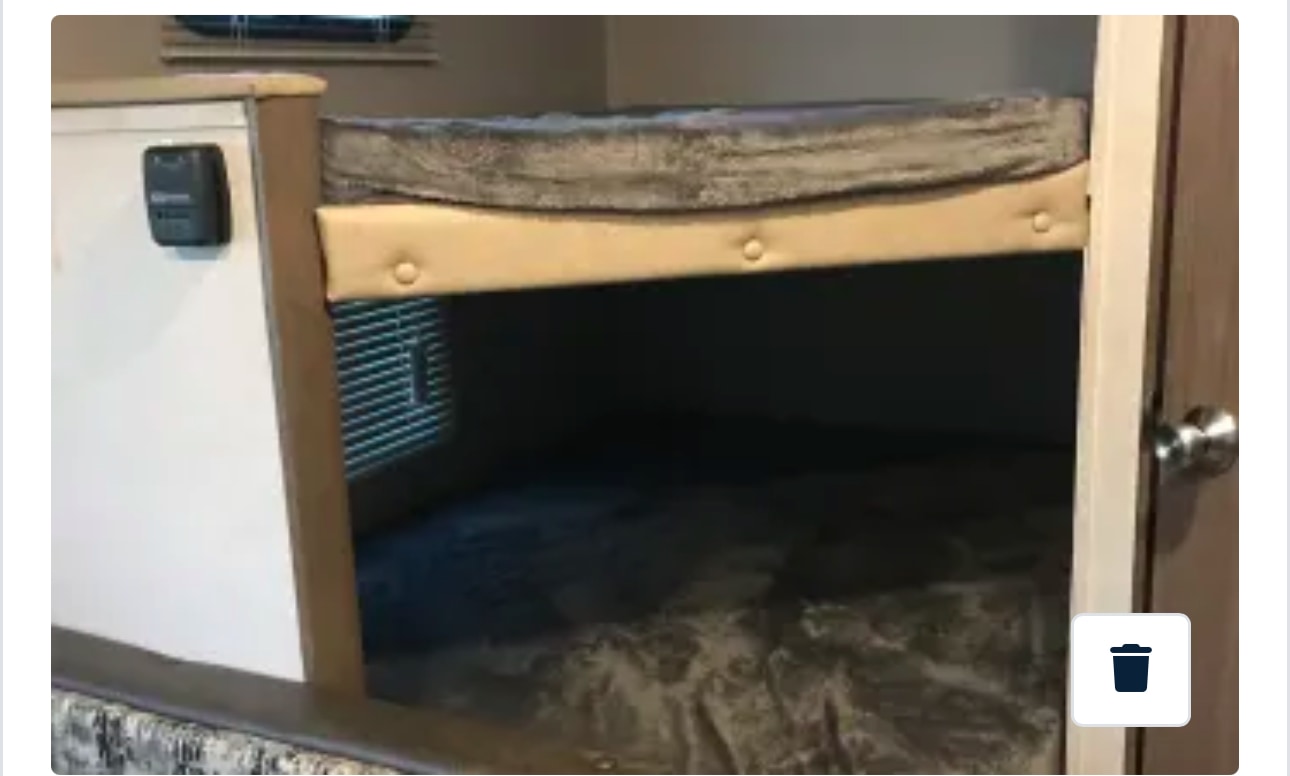 Comfortable bunk beds in an RV rental, perfect for family travel. Features a thermostat and window blinds.. Keystone RV Hideout 2019