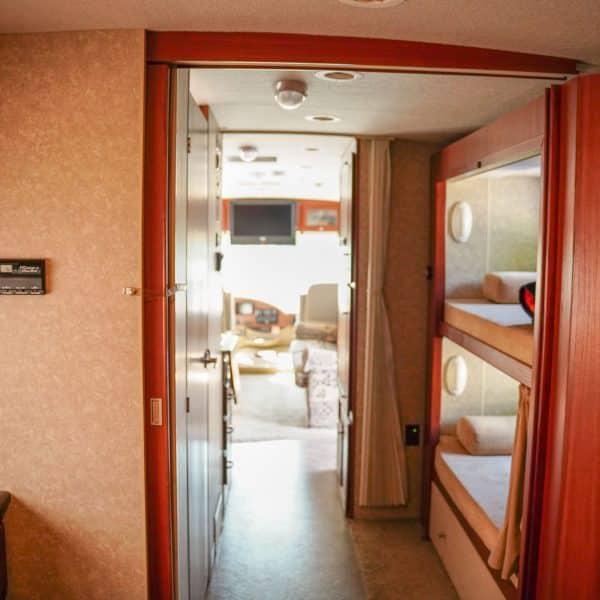 Experience this rv rental! Features a hallway, a bright living area, and compact built-in bunk beds. Ideal for family adventures.. Winnebago Vista 2009