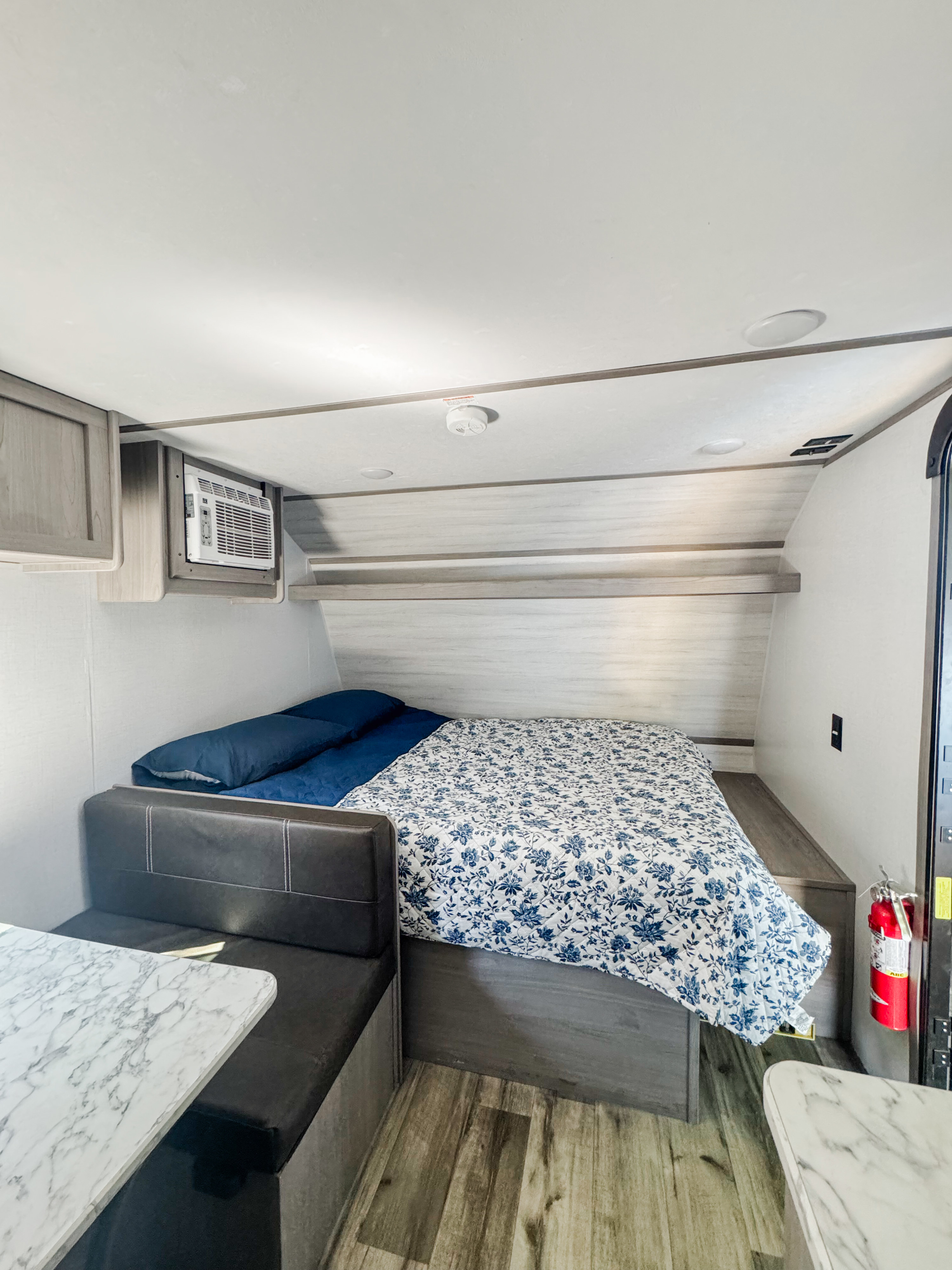 This compact RV rental features a comfortable bed, a dinette with a marble table, and built-in AC.. Dutchmen Coleman Lantern LT 2023