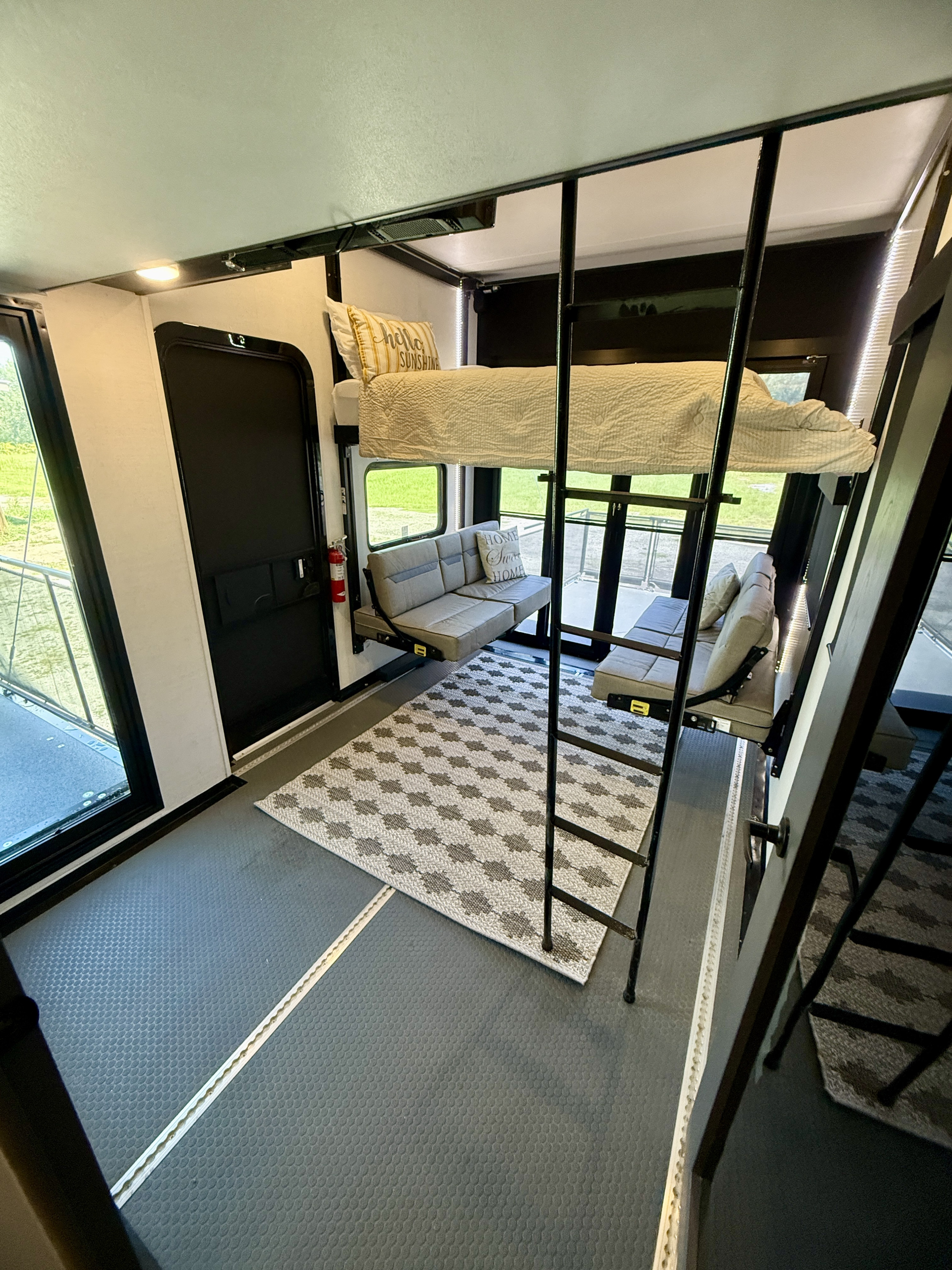 Spacious RV rental toy hauler interior, featuring a bunk bed, versatile sofa beds, and a large garage area.. Aliance Valor 2024