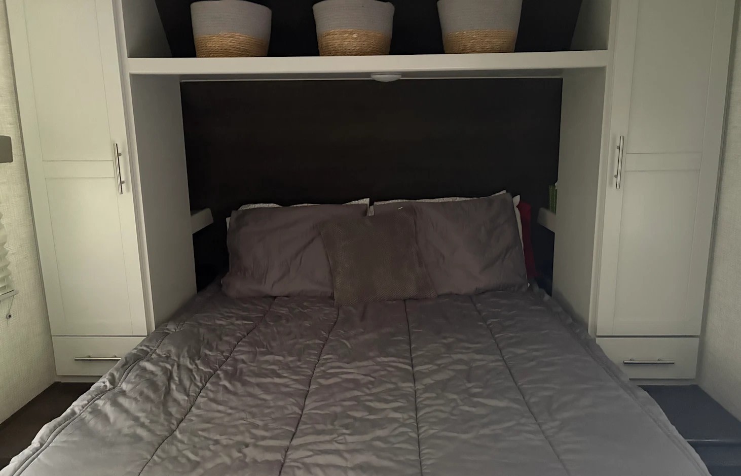 Cozy RV rental bedroom with a comfy bed, overhead shelf, and built-in wardrobes. Perfect for a restful night.. Keystone RV Bullet Crossfire 2021