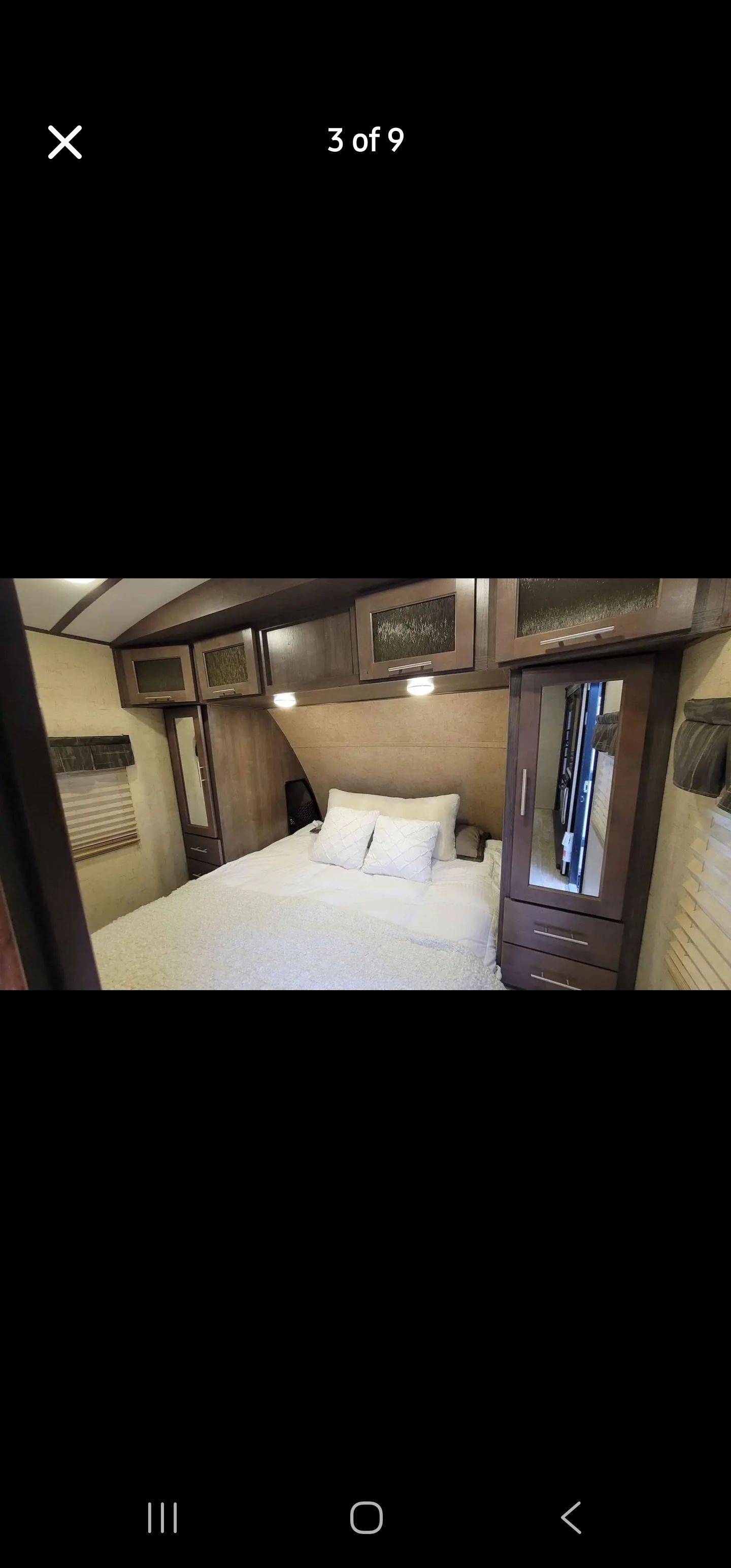 RV rental master bedroom features a cozy bed, ample storage, and warm lighting for your comfort.. Forest River Surveyor 2016