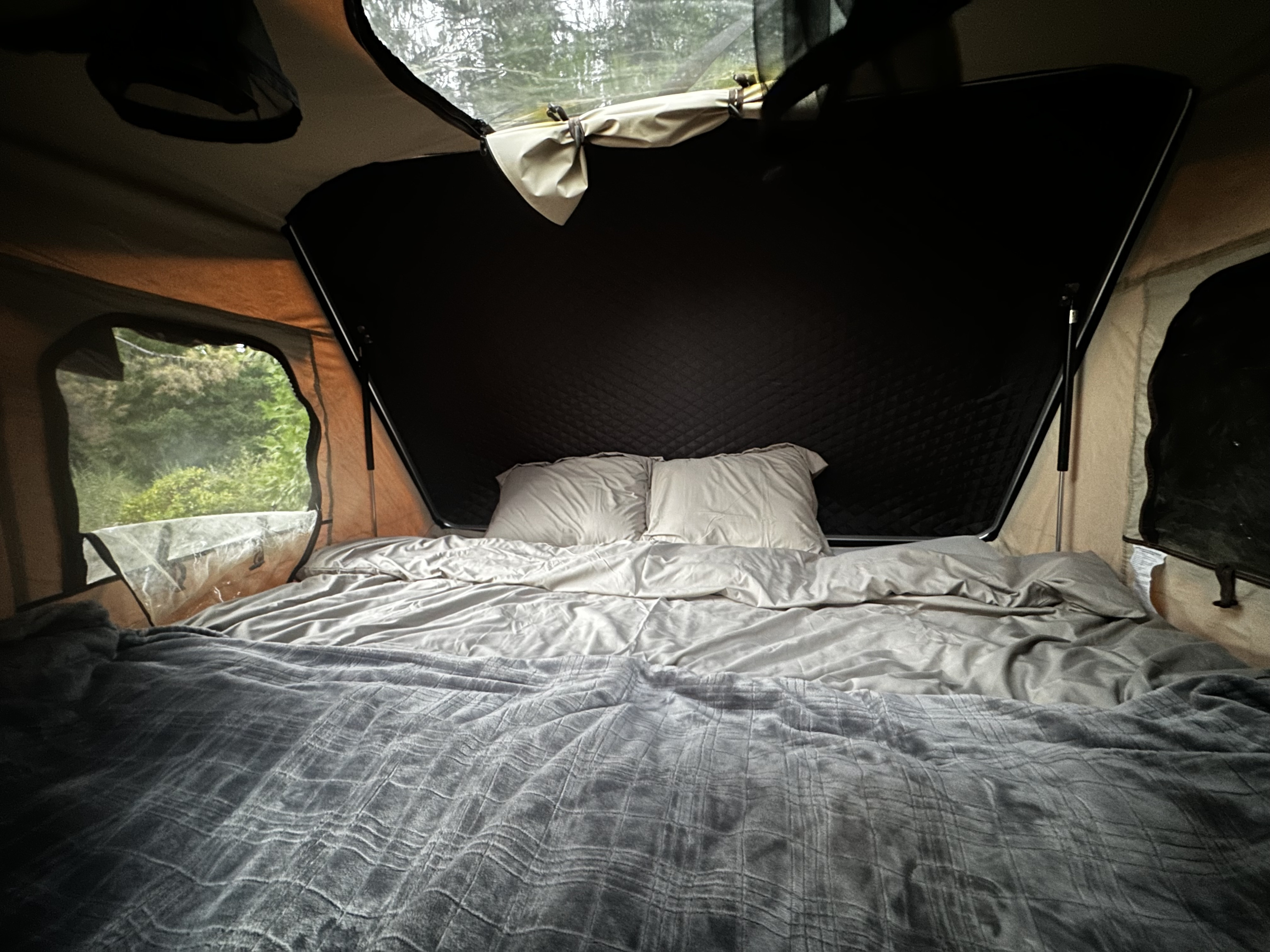 Cozy RV rental pop-up tent features a comfortable bed and immersive nature views for camping.. Toyota FJ Cruiser 2007