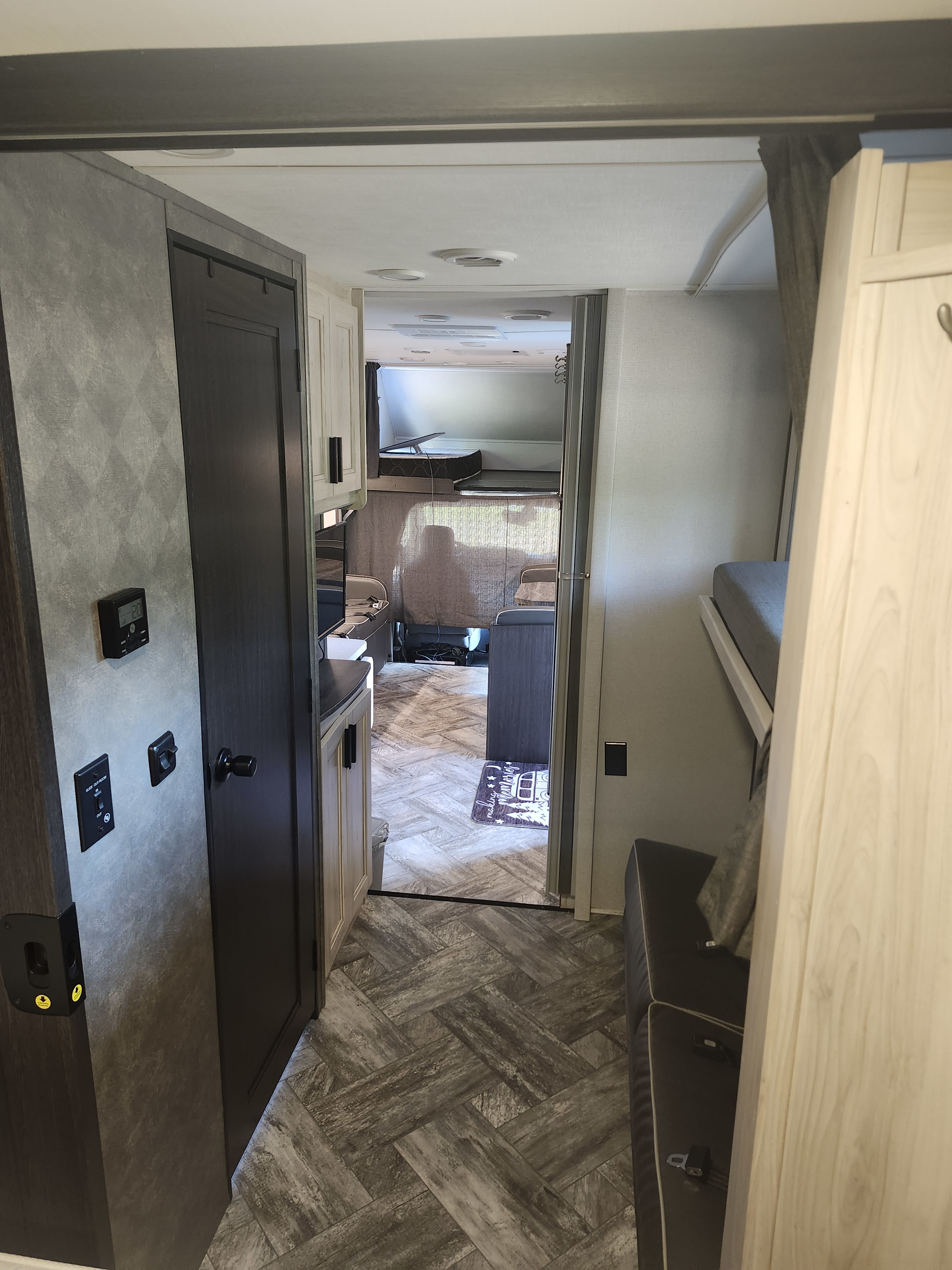 This inviting rv rental interior features bunk beds, a compact kitchen, and a cozy seating area with patterned flooring.. Forester LE 2023