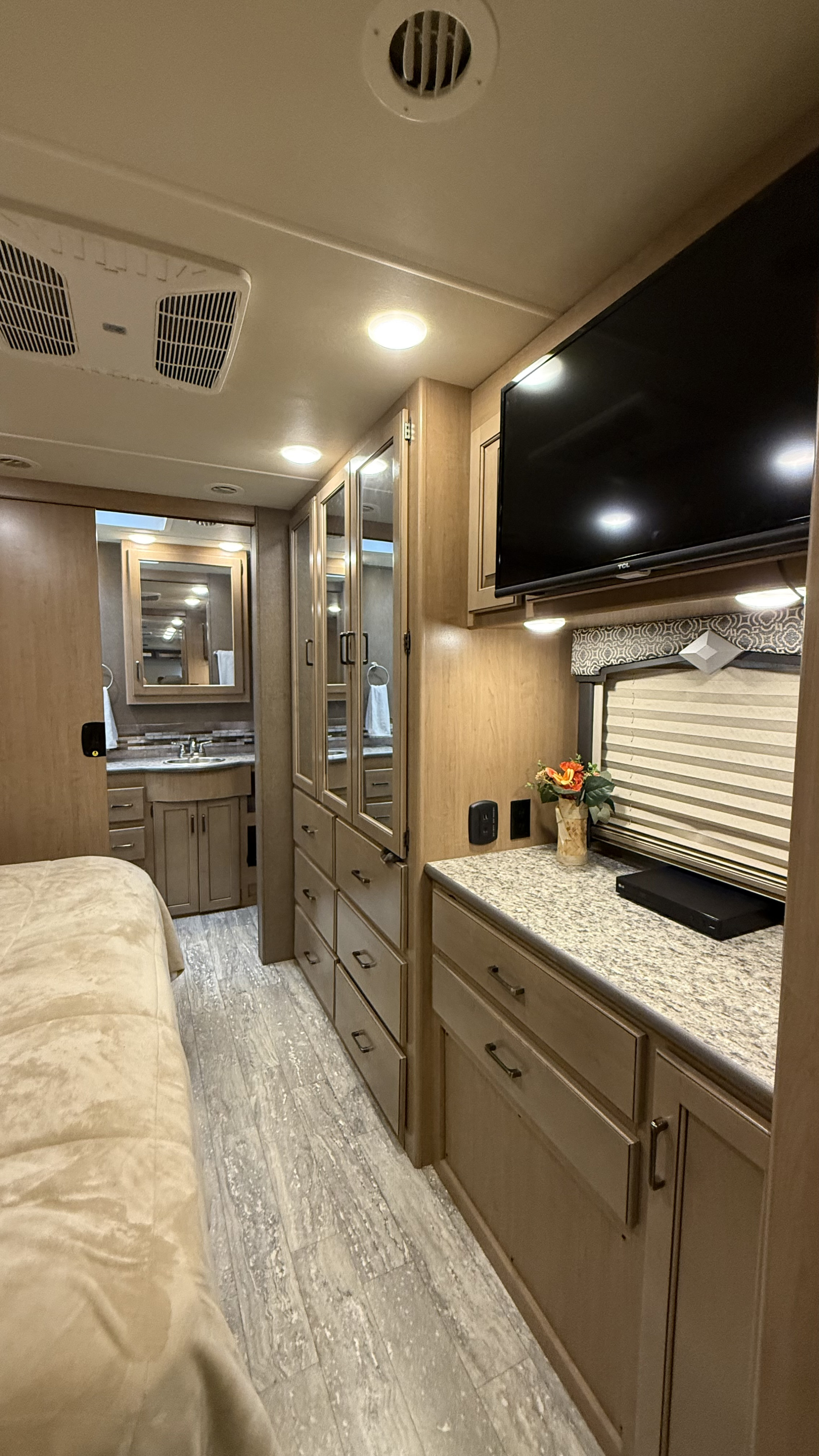 Explore this clean RV rental interior featuring a bedroom, bathroom, storage, and entertainment. Your home on the road.. Thor Hurricane 2019