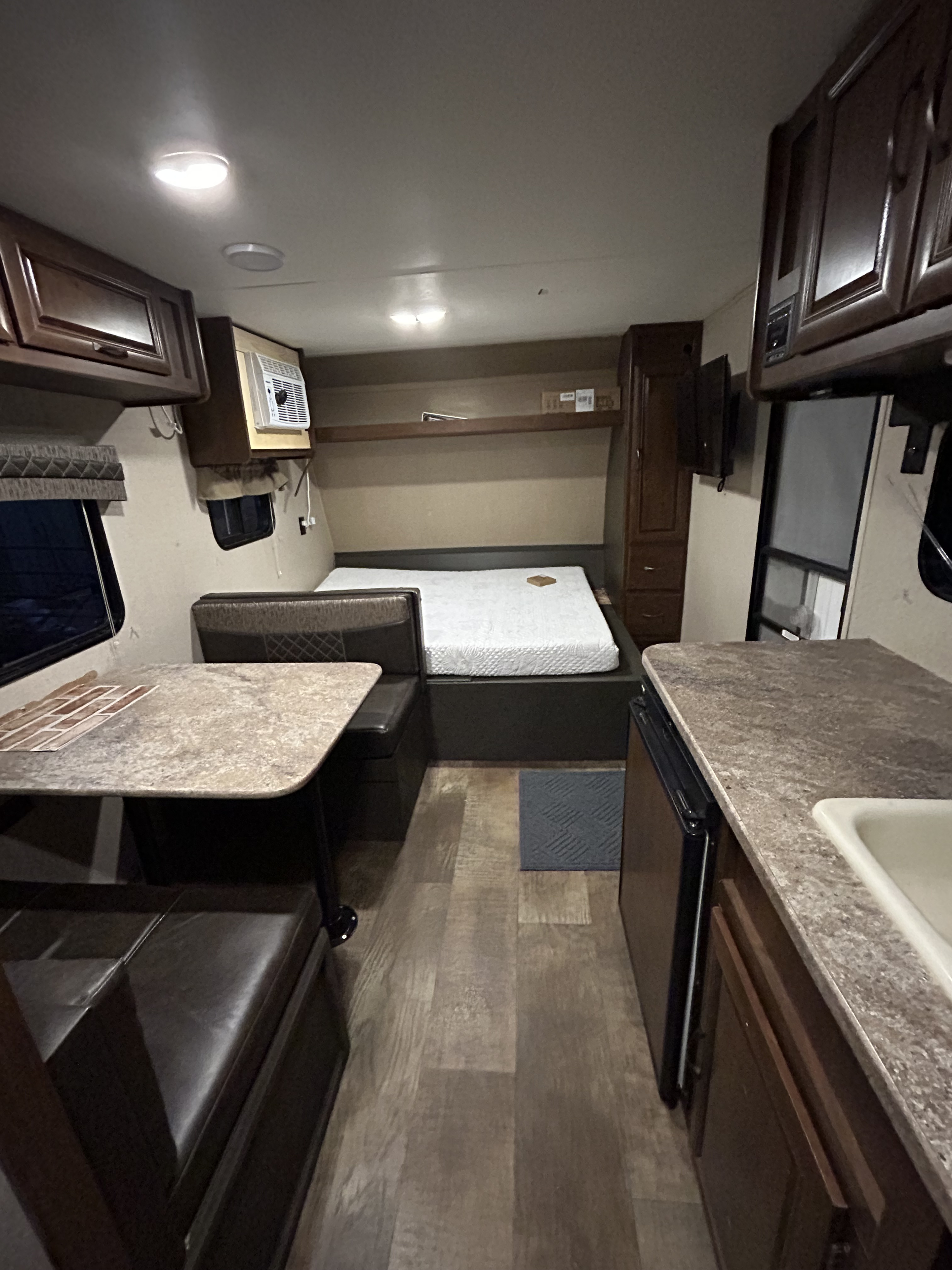 Explore this RV rental's interior: a compact living area with bed, dinette, and kitchen amenities.. Crossroads RV Z-1 Lite 2017