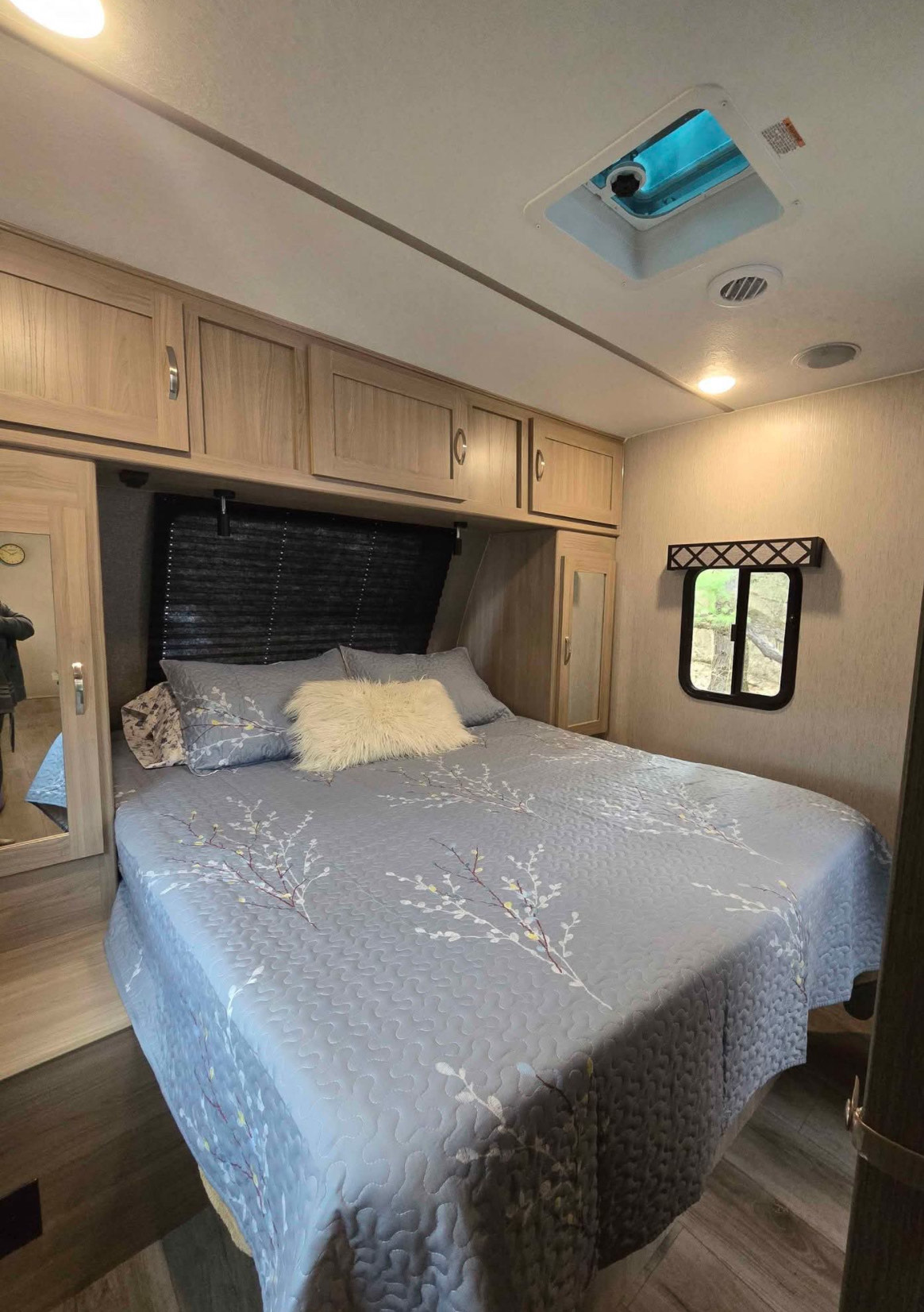 Spacious RV rental bedroom features a comfy queen bed, ample storage, and natural light. Perfect for travel.. Coachmen Forest River Freedom Express Liberty Series M-320 BHDS 2021