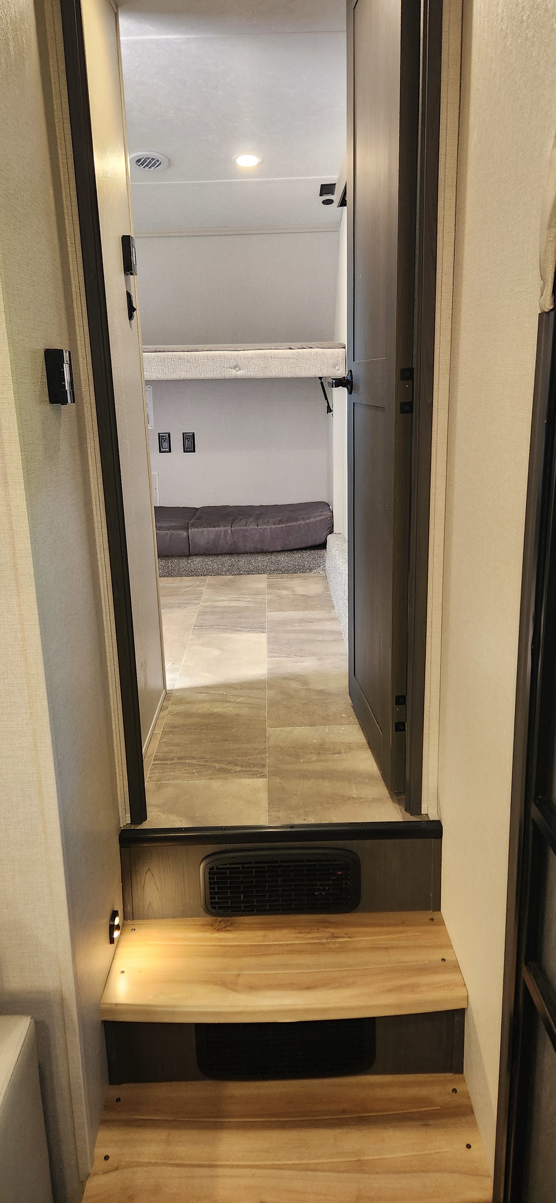 Explore this rv rental bunkhouse: Upper and lower beds, bright interior, and steps lead to comfortable living.. Coachmen Chaparral 2025