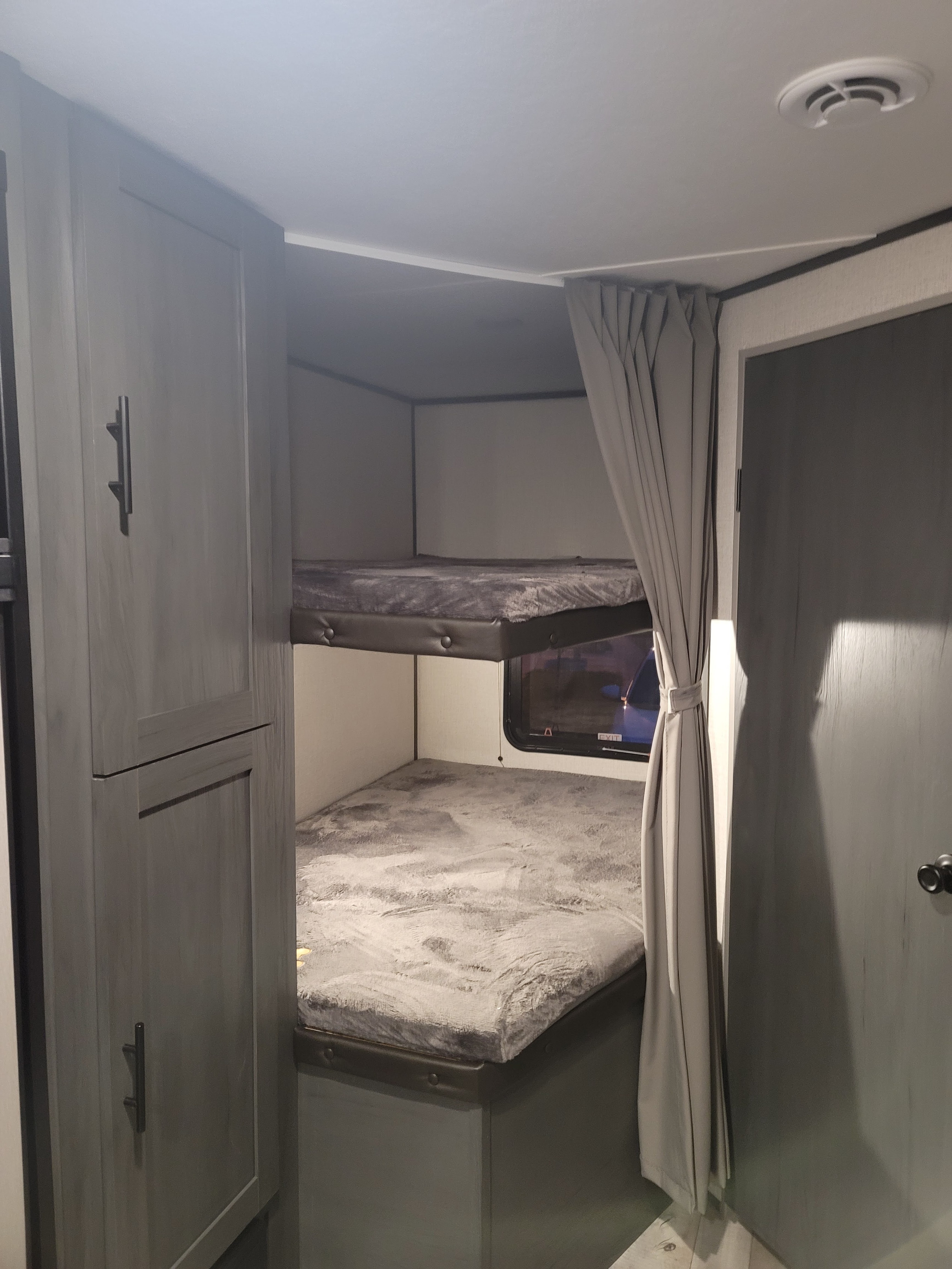 RV rental with modern interior: bunk beds, storage, and cozy setup for family adventures.. Colorado 26bhc 2021